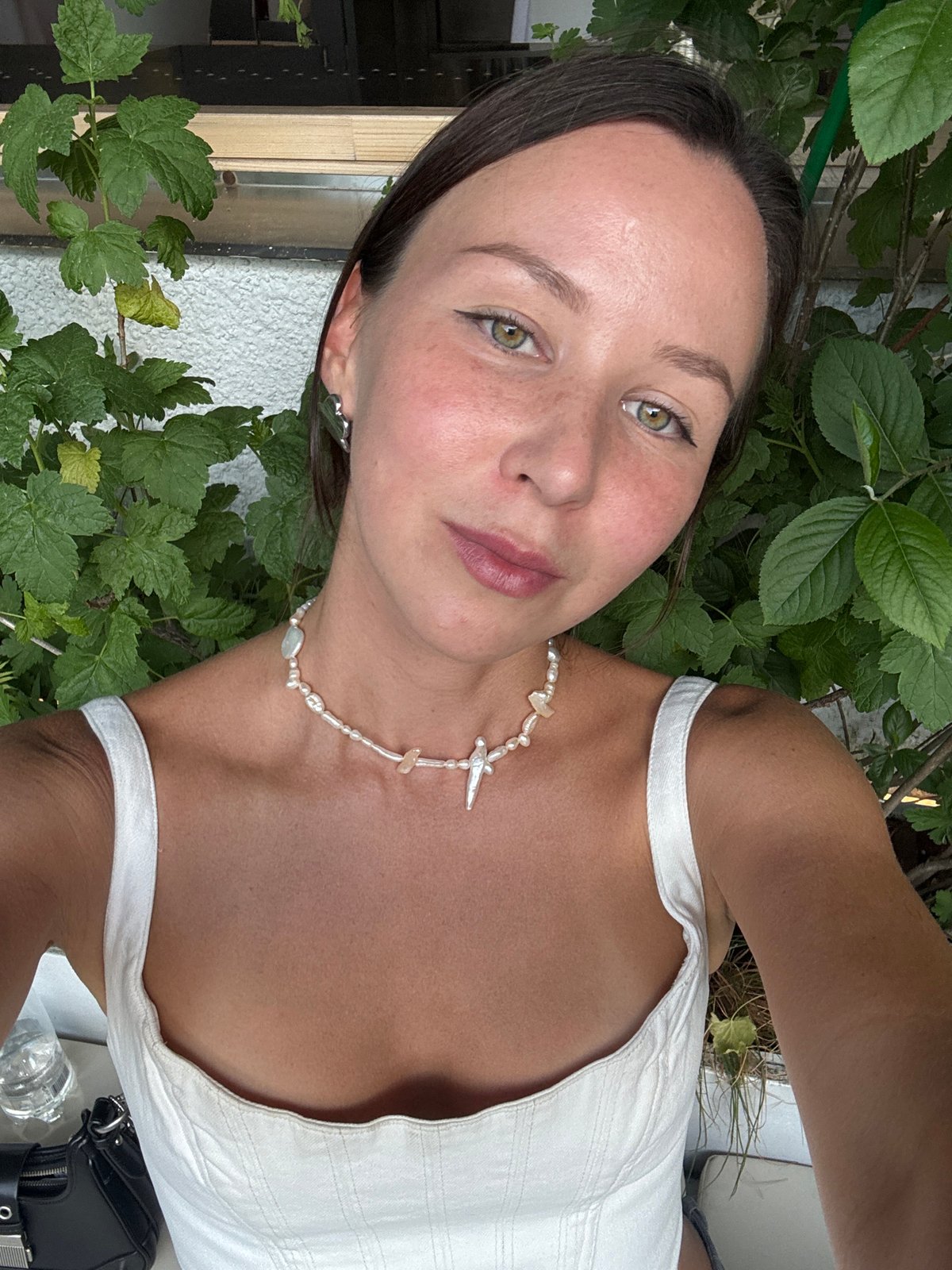 Woman enjoys wine, meal and selfies at Moscow outdoor venue