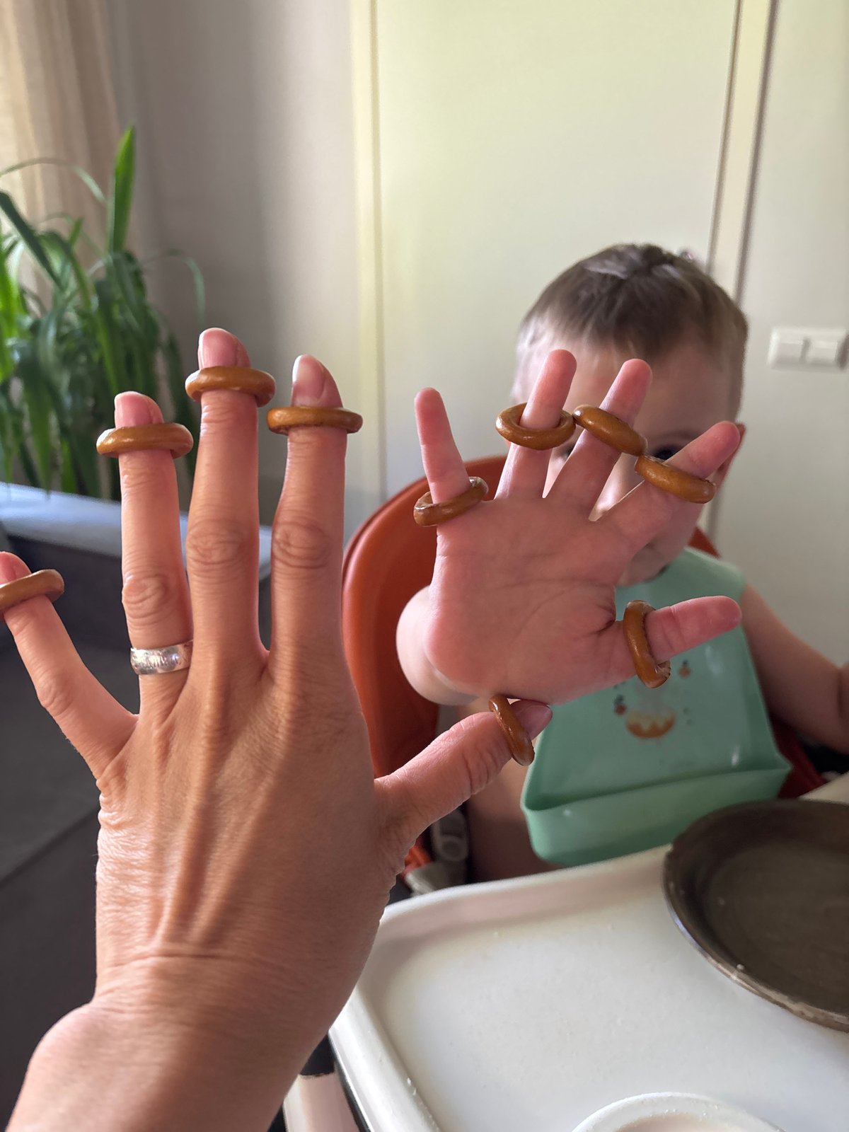 Adult and child wear pretzel rings as fingertip jewelry