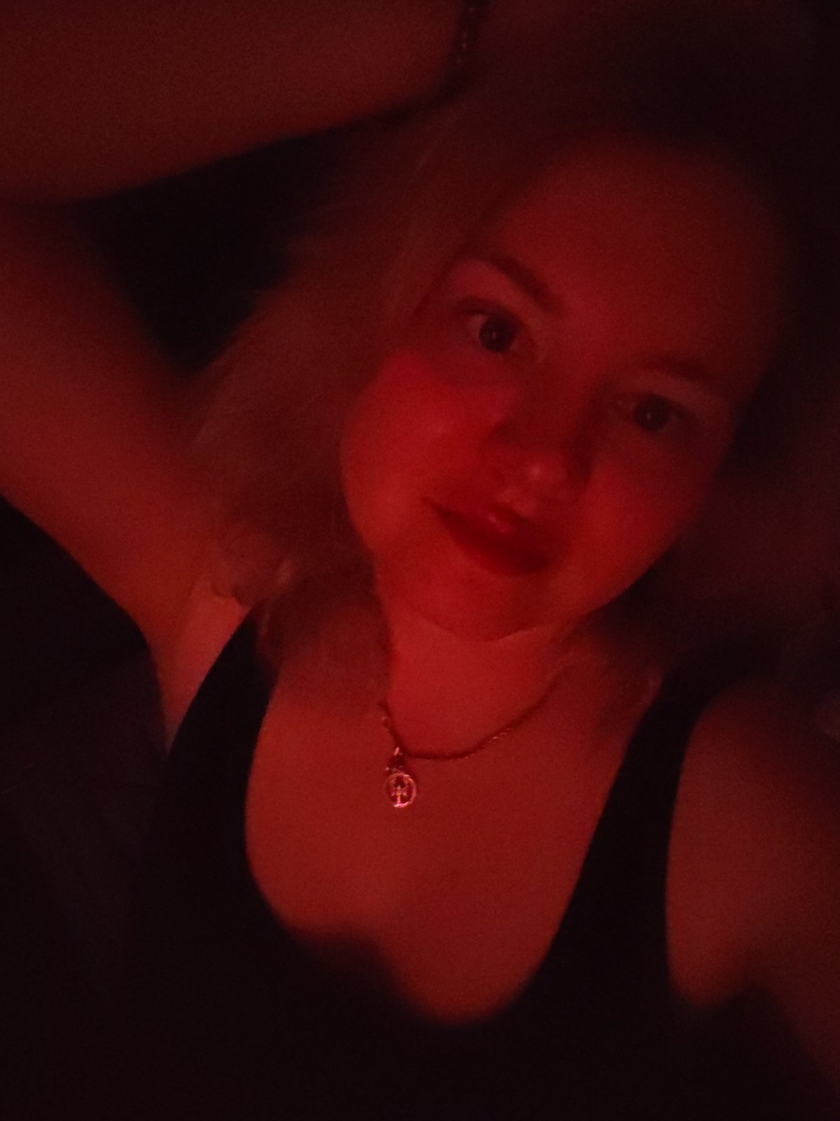 Woman takes selfies in red-lit room in Izhevsk