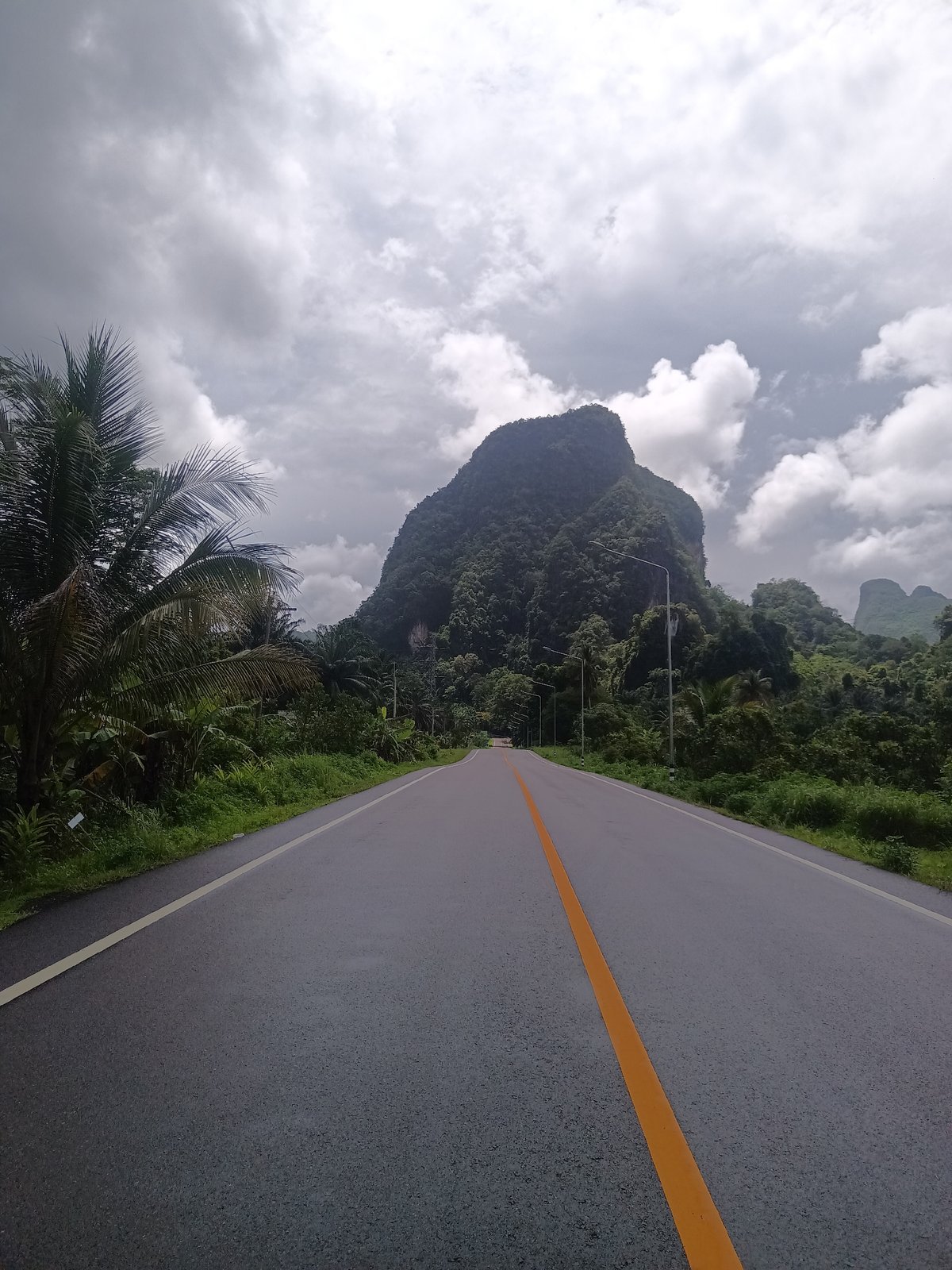 Rural road and Thai Buddha shrine documented during morning journey