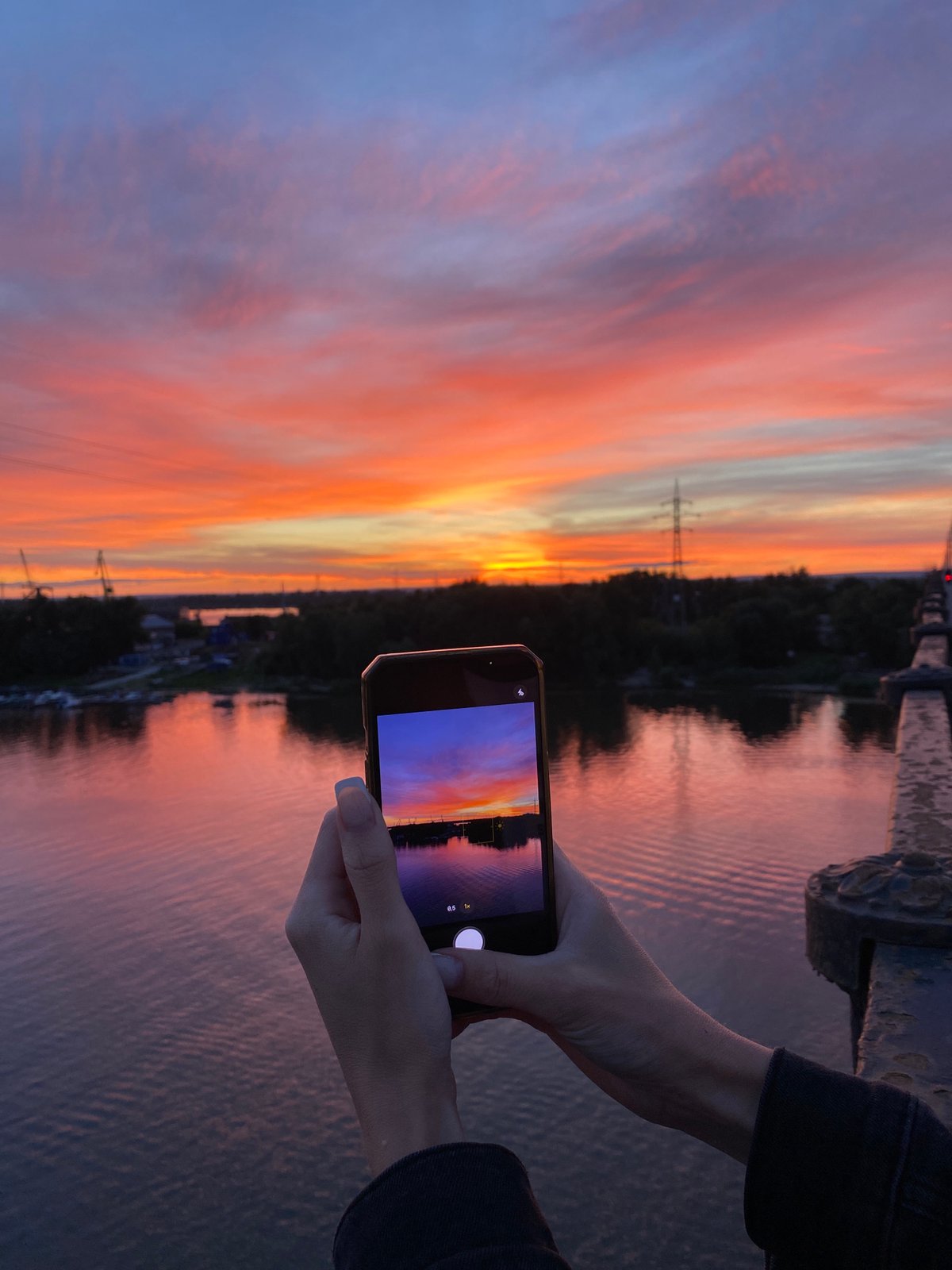 Sunset from a bridge, sky reflected on the river below