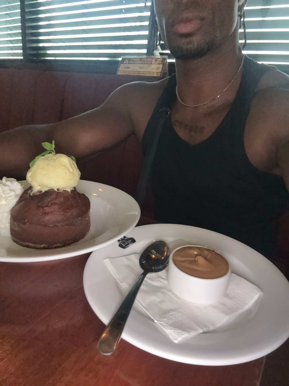 Man enjoys drinks and dessert at restaurant bar
