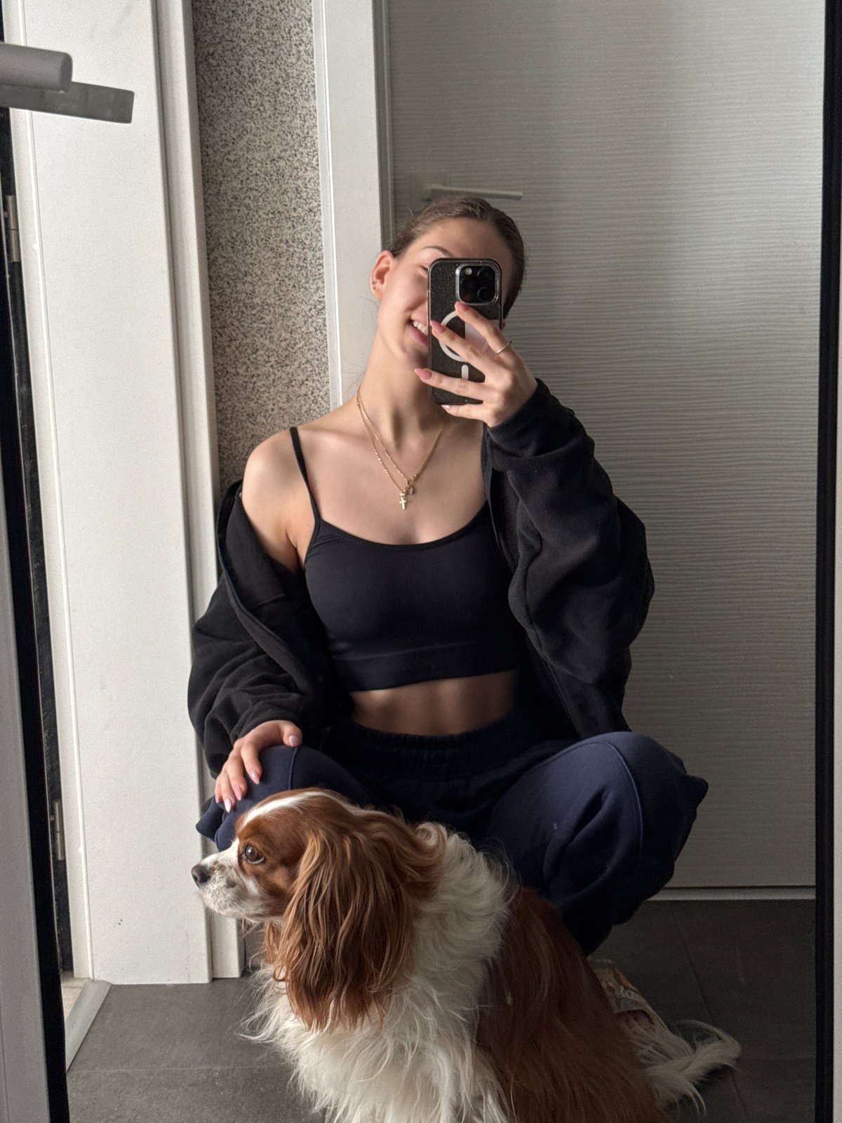 Woman takes mirror selfie in athletic wear, Sofia