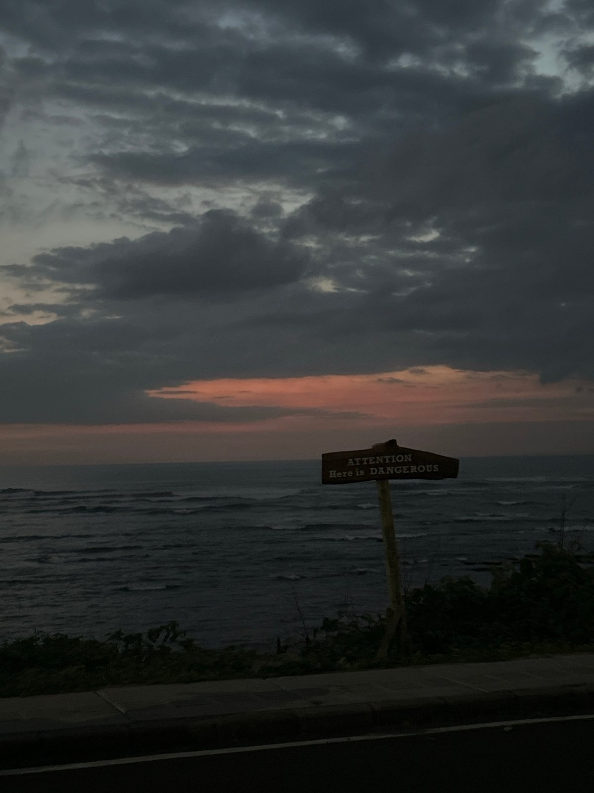 Stormy weather documented along Mengwi coastline, warning signs visible