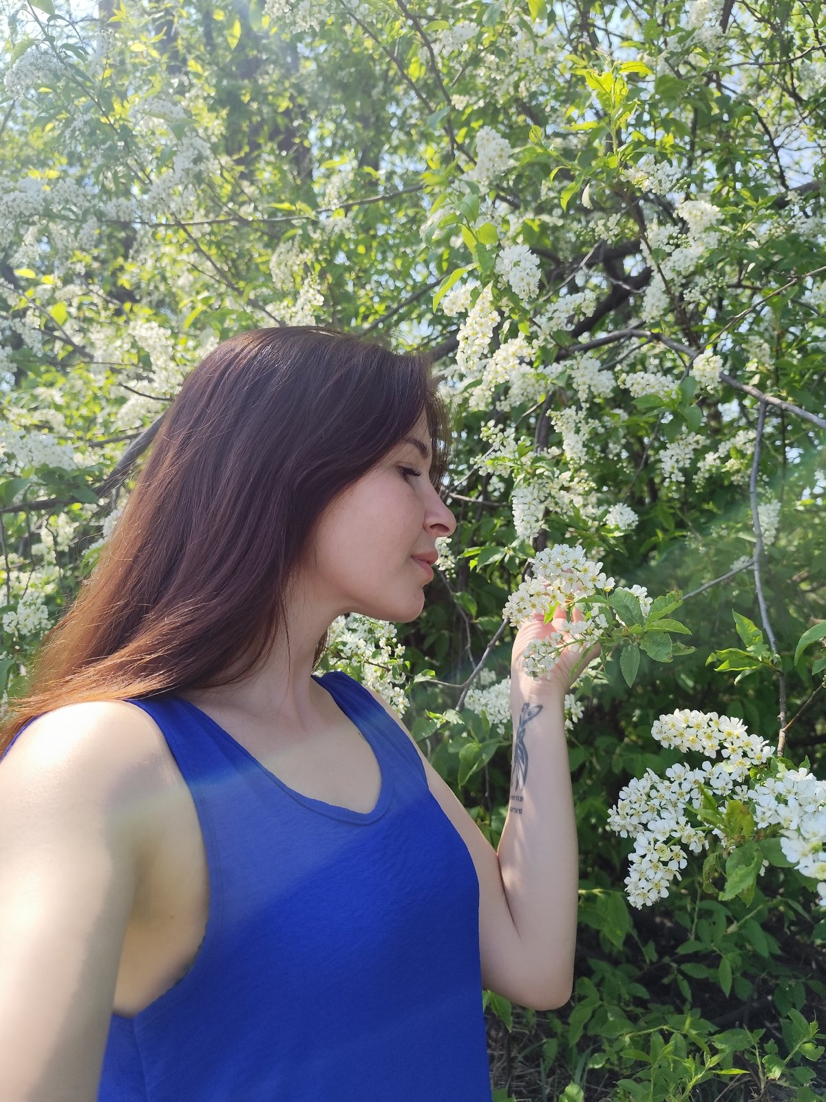 Woman enjoys spring blossoms in Foki, Russia park