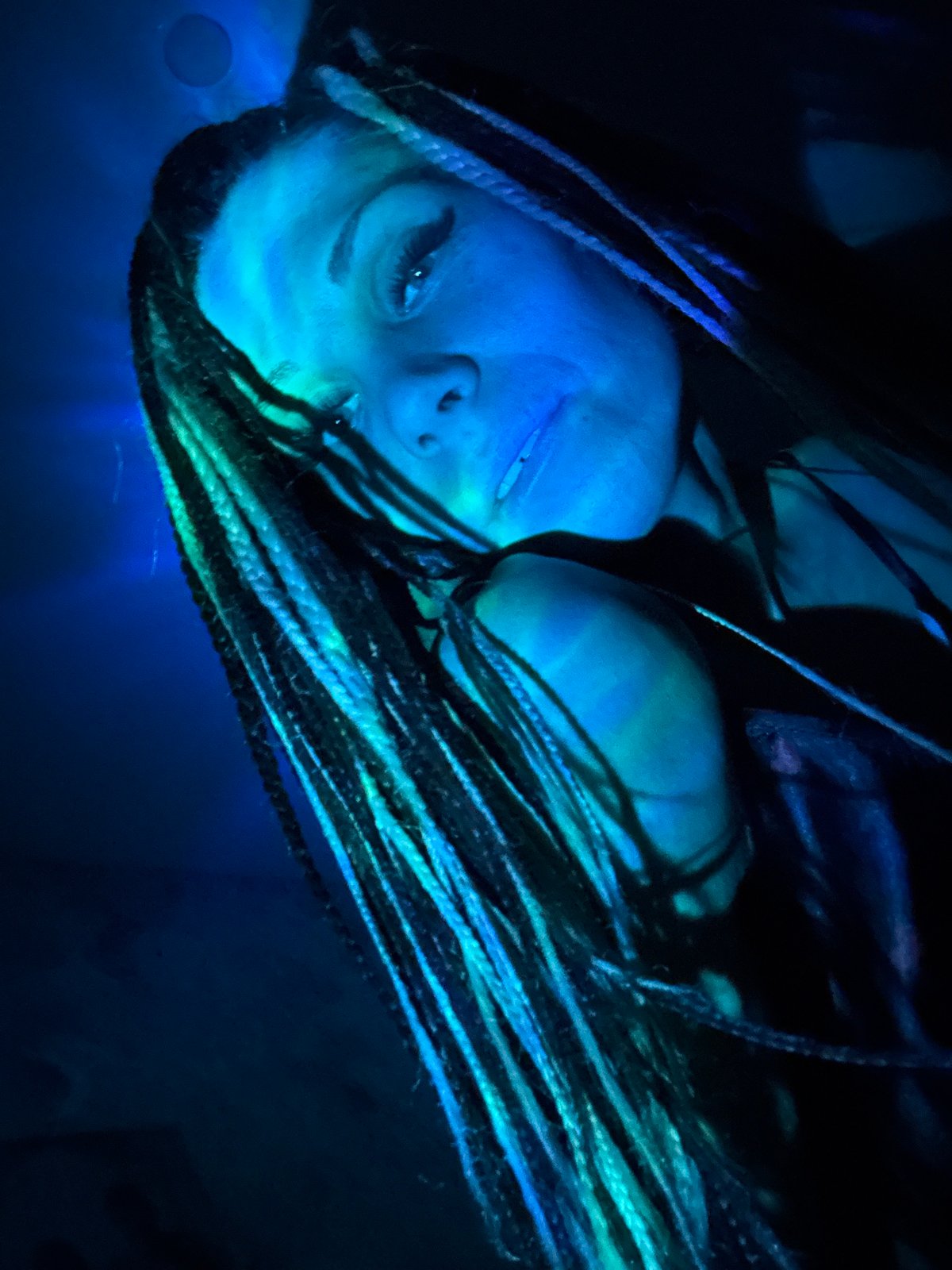 Artistic portrait session with colored lighting documented in Rusanovo