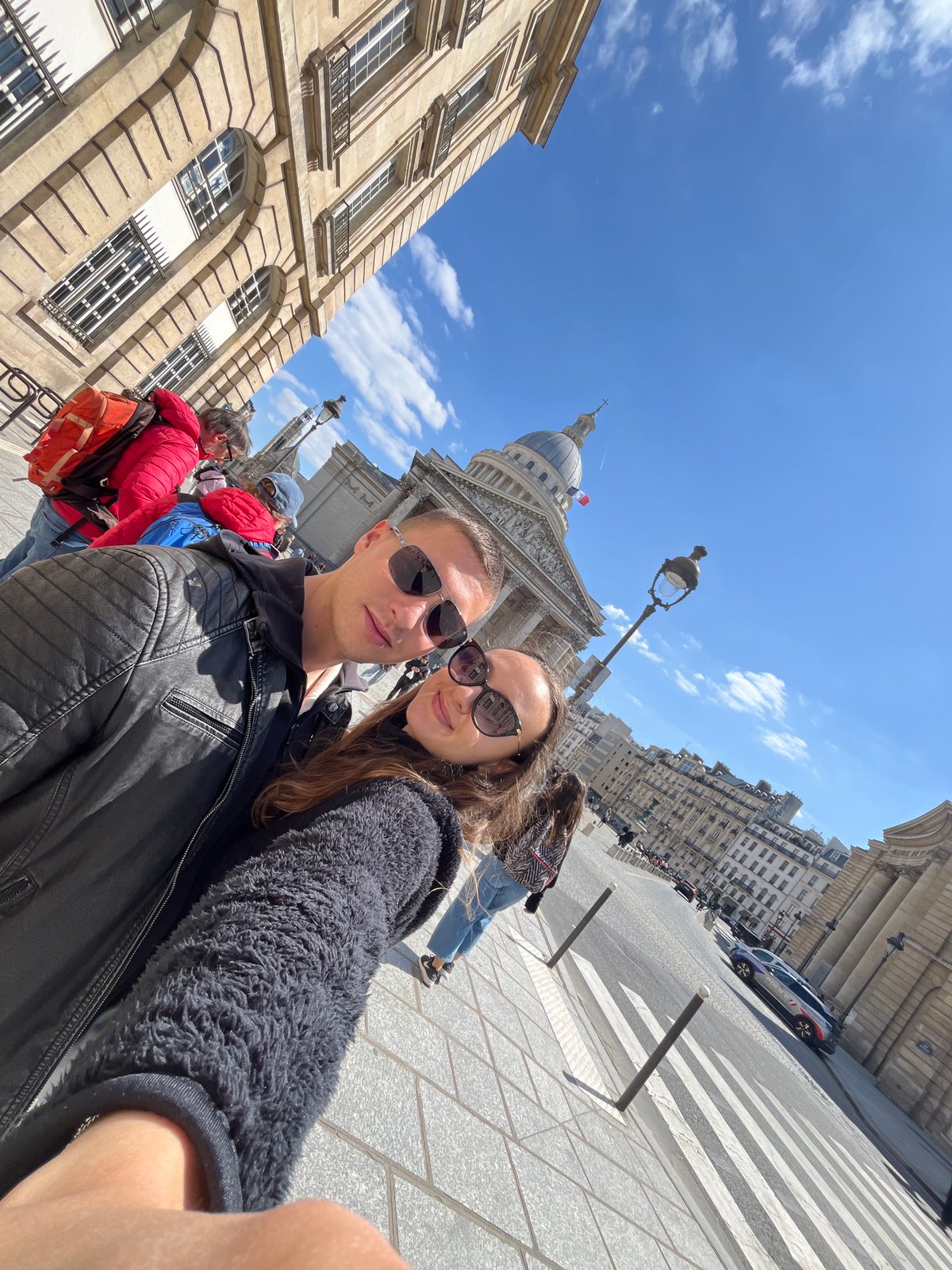 Tourists photograph Panthéon under clear Paris skies