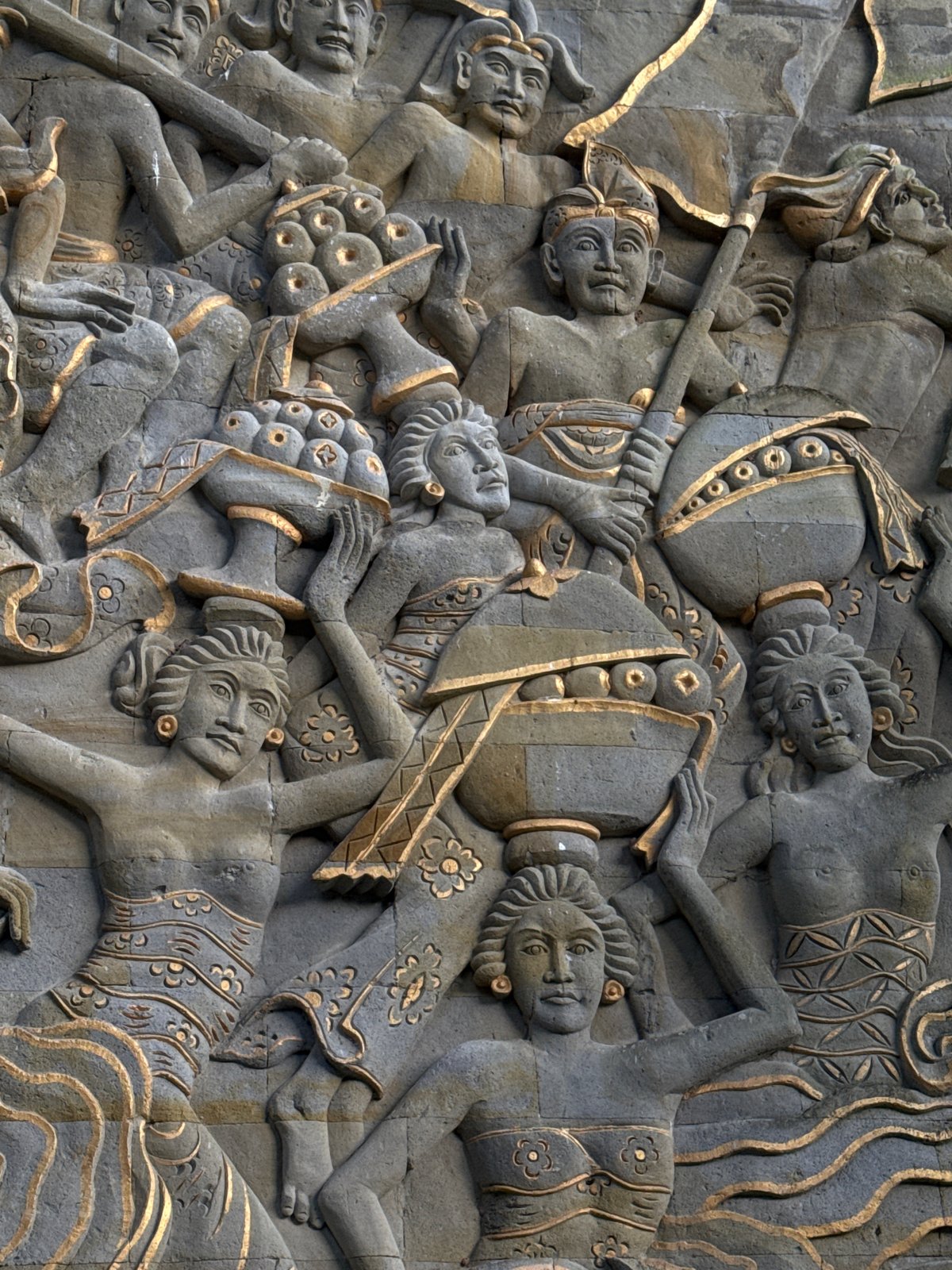 Tourist explores Balinese resort grounds with traditional sculptures and gardens
