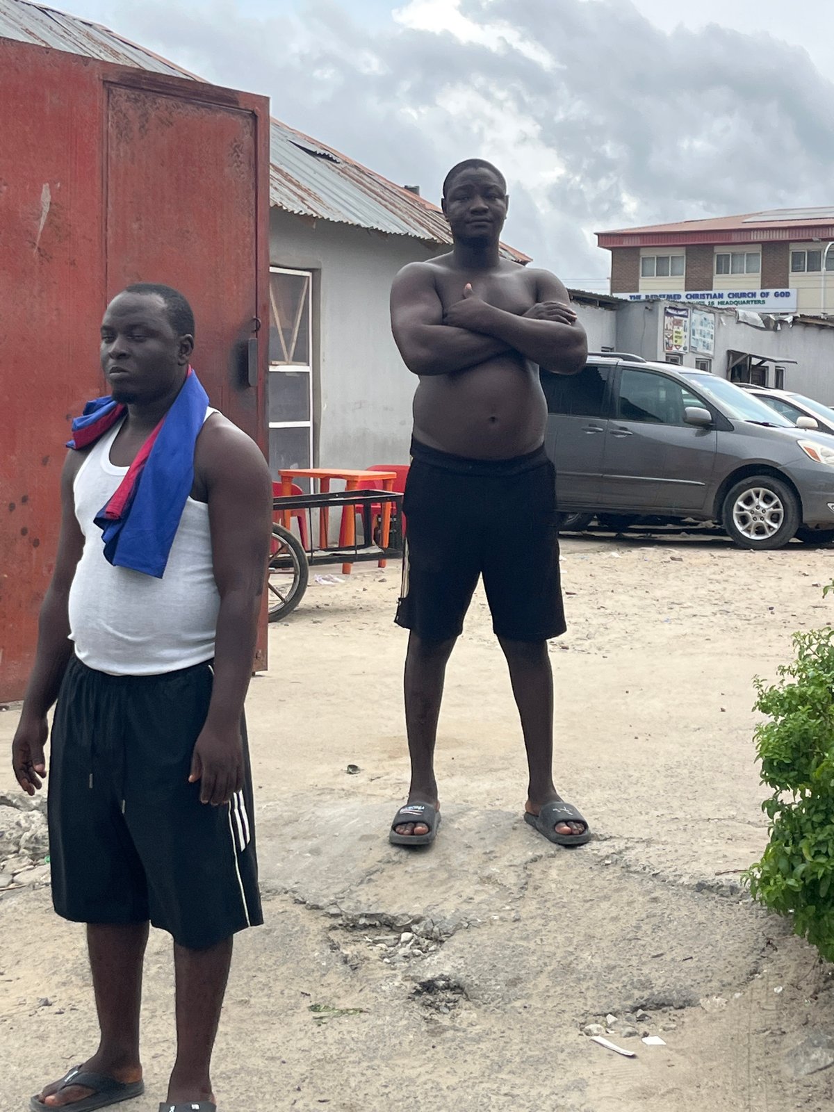Men gather outside in Itirin, Nigeria
