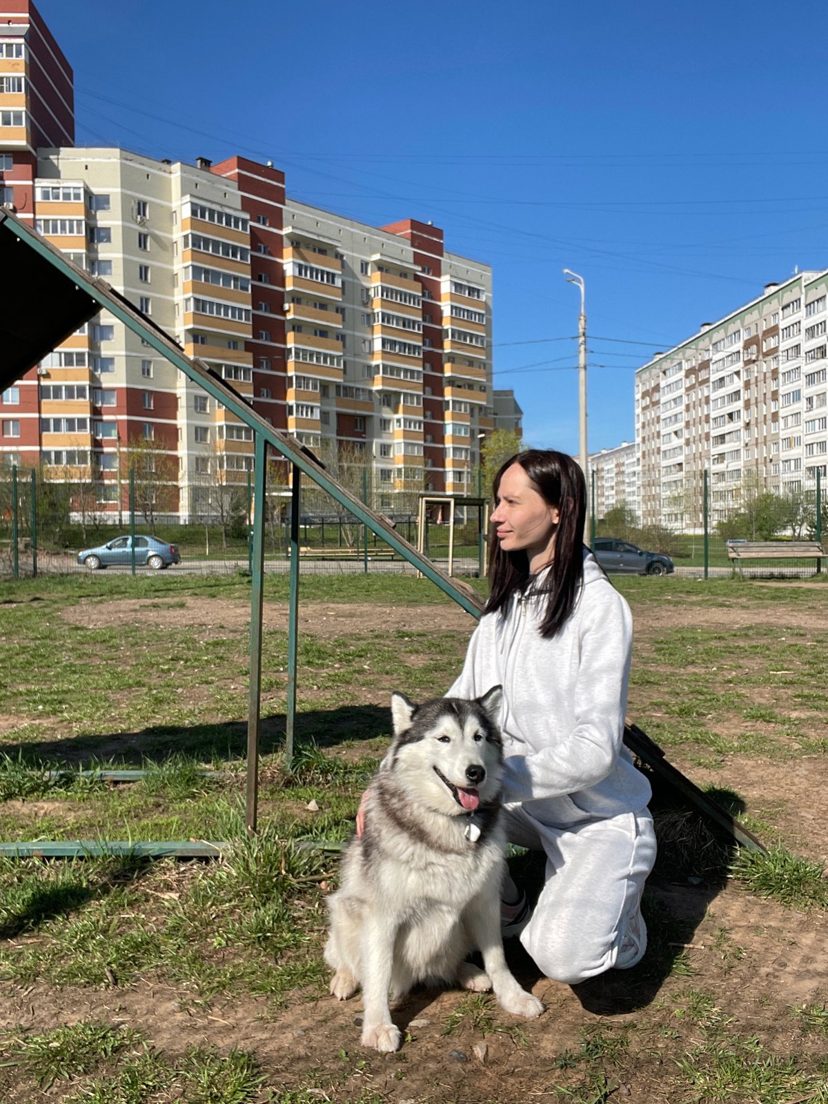 Woman pets husky in park in Светлое, Russia