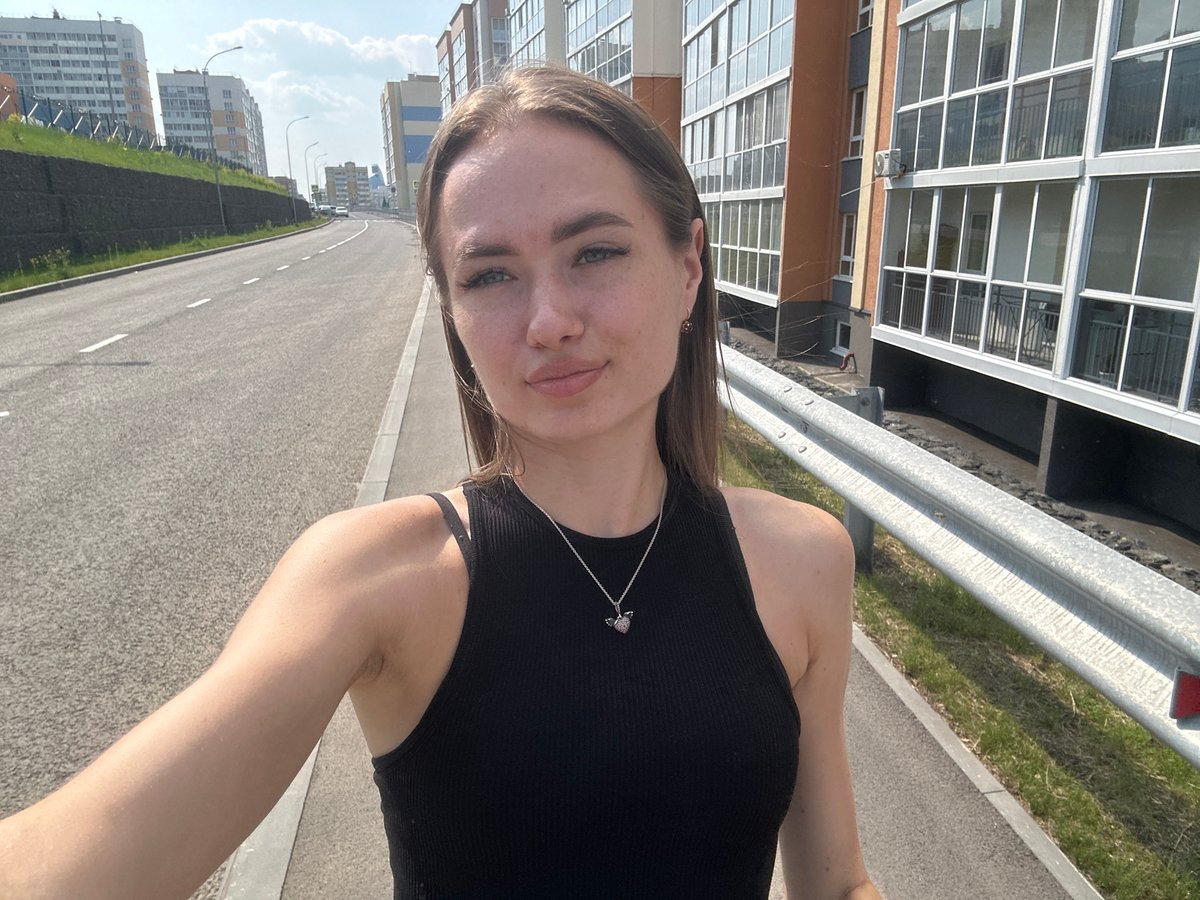 Selfies outside a colorful high-rise residential complex