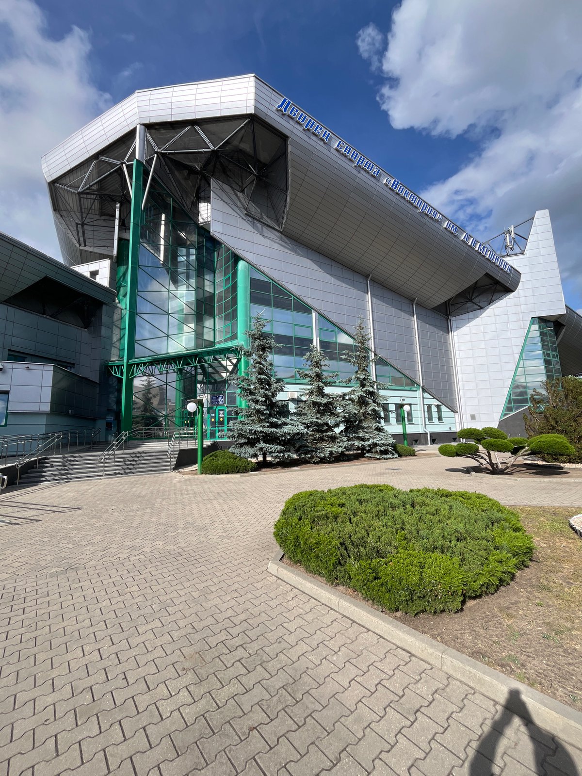 Modern sports arena complex exterior documented by witnesses