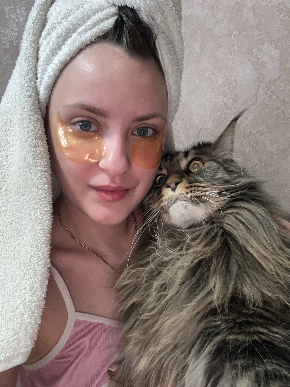 Woman rests with large cat in Марковский, Russia