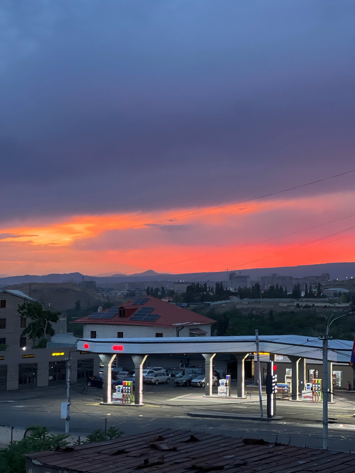 Sunset observed over Yerevan cityscape during evening twilight