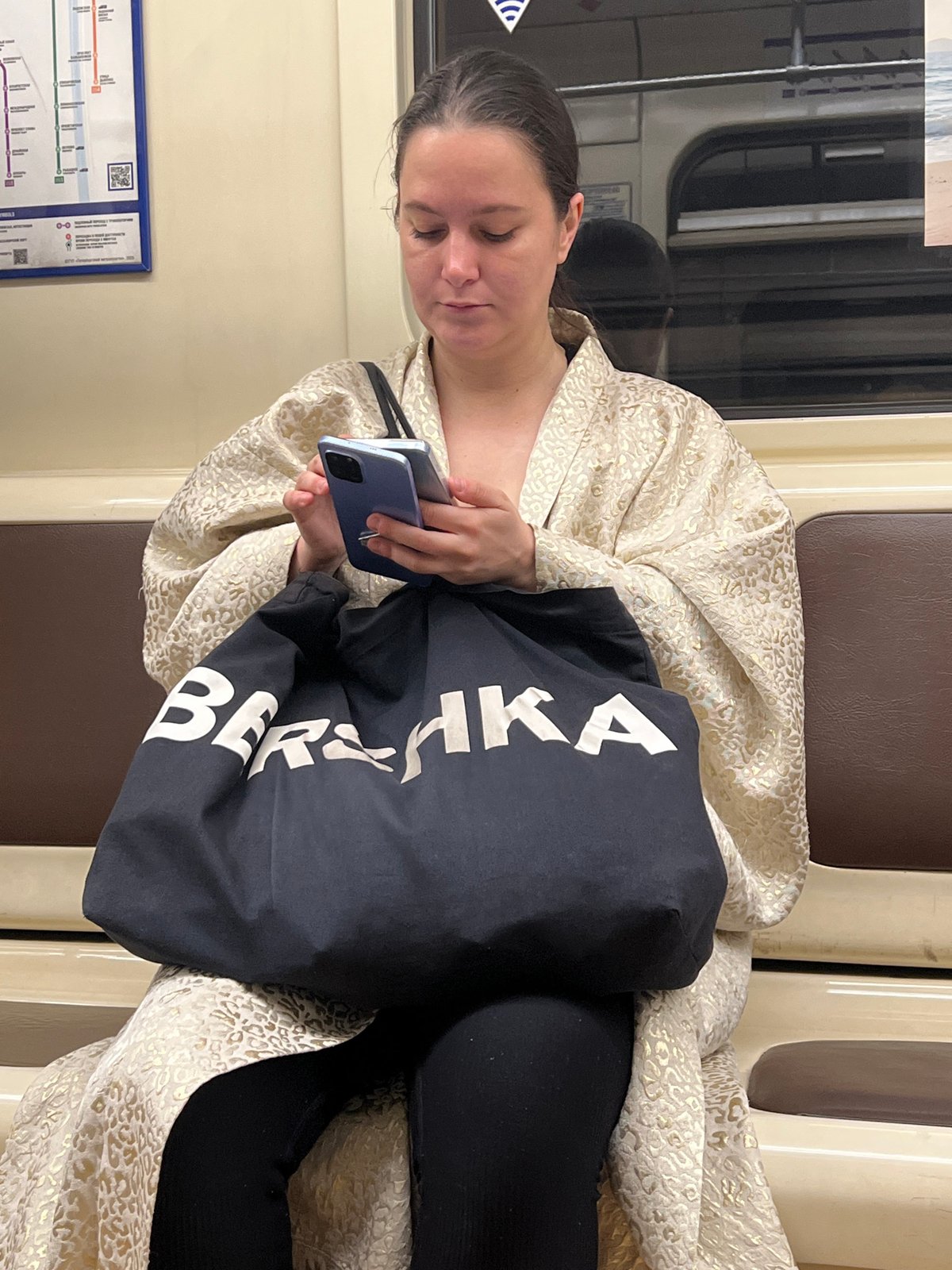Woman uses smartphone on train in Saint Petersburg