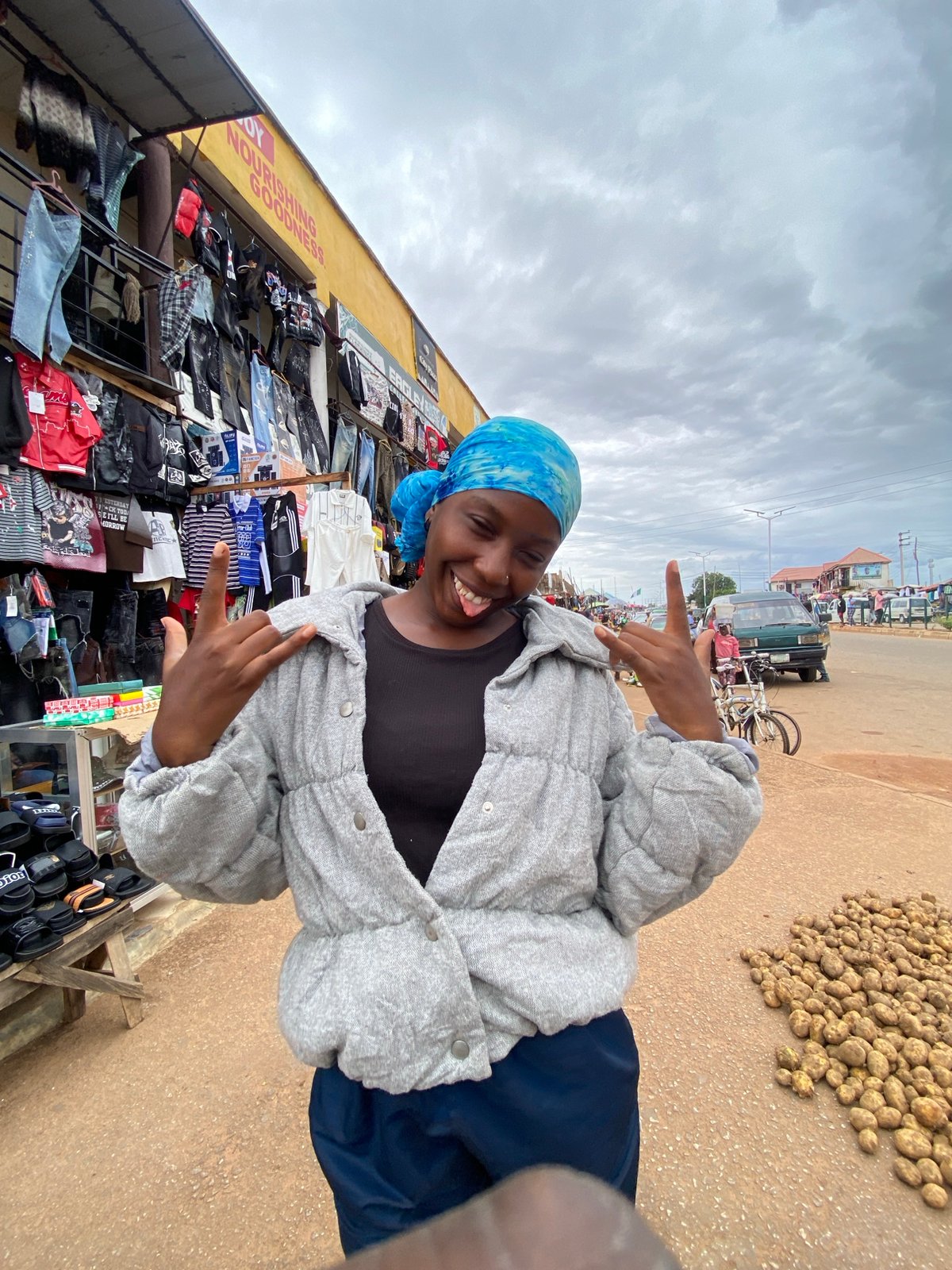 Street market day in Bukuru, Nigeria — clothing, electronics, and produce