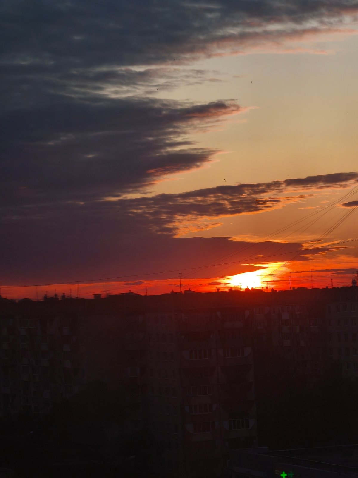 Dramatic sunset illuminates Yoshkar-Ola as evening life unfolds