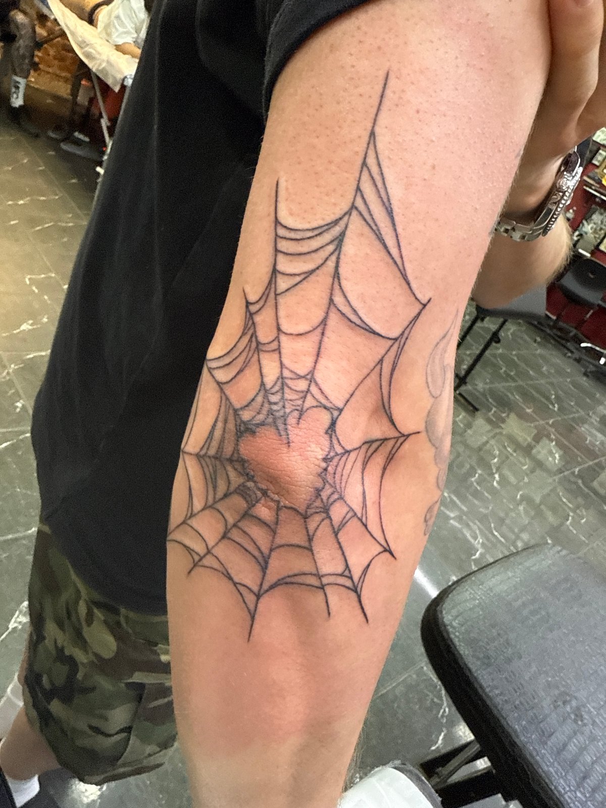 Spiderweb elbow tattoo documented in Moscow