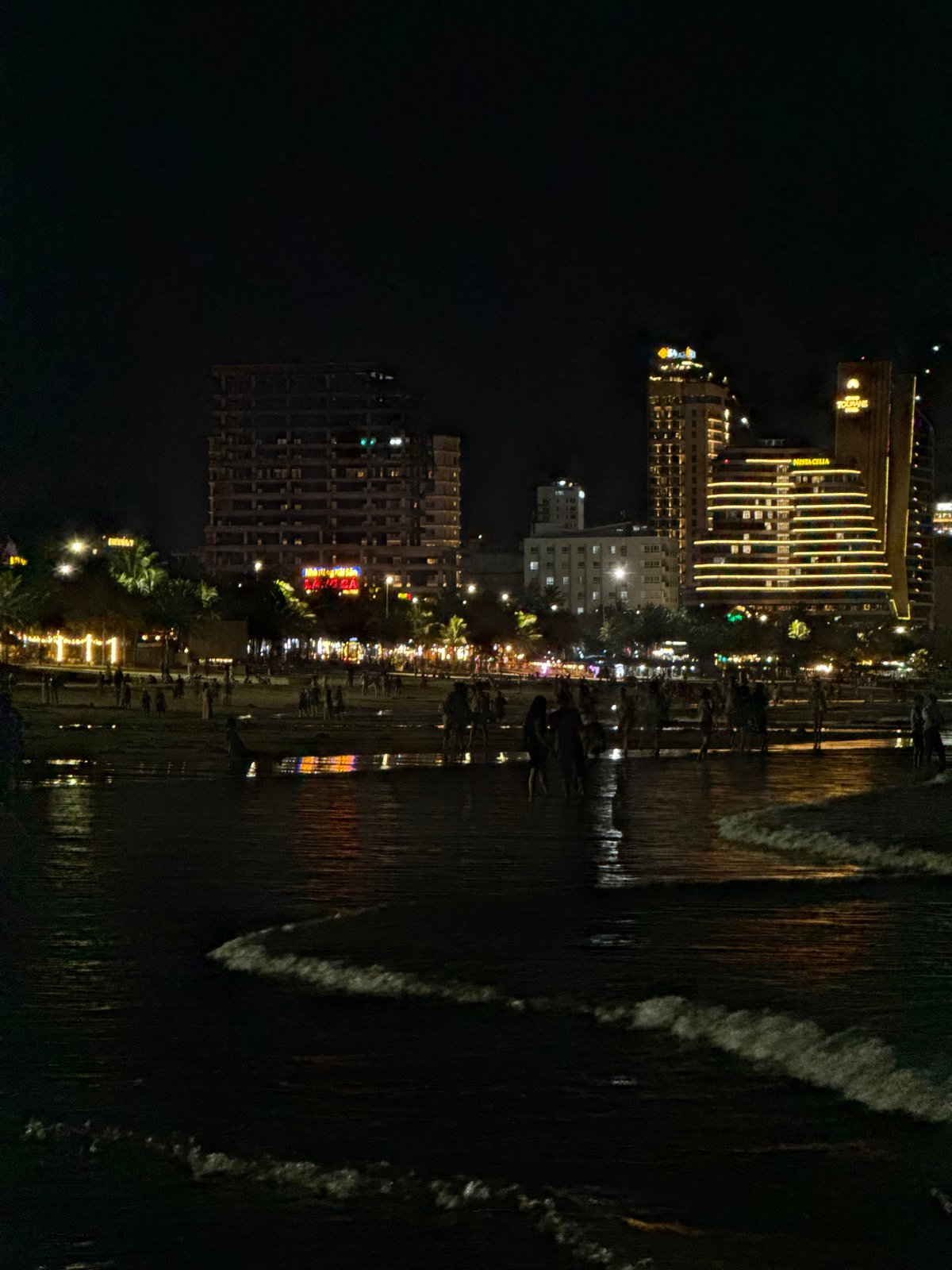 Da Nang beachfront at night, city lights and shoreline activity