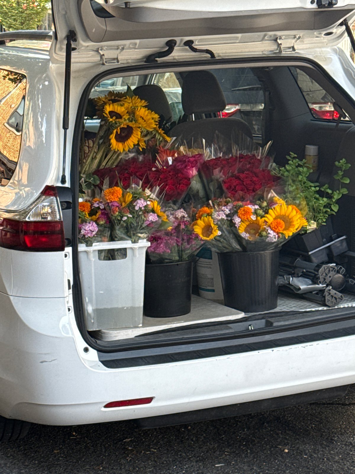 Minivan trunk loaded with fresh flower bouquets in New York