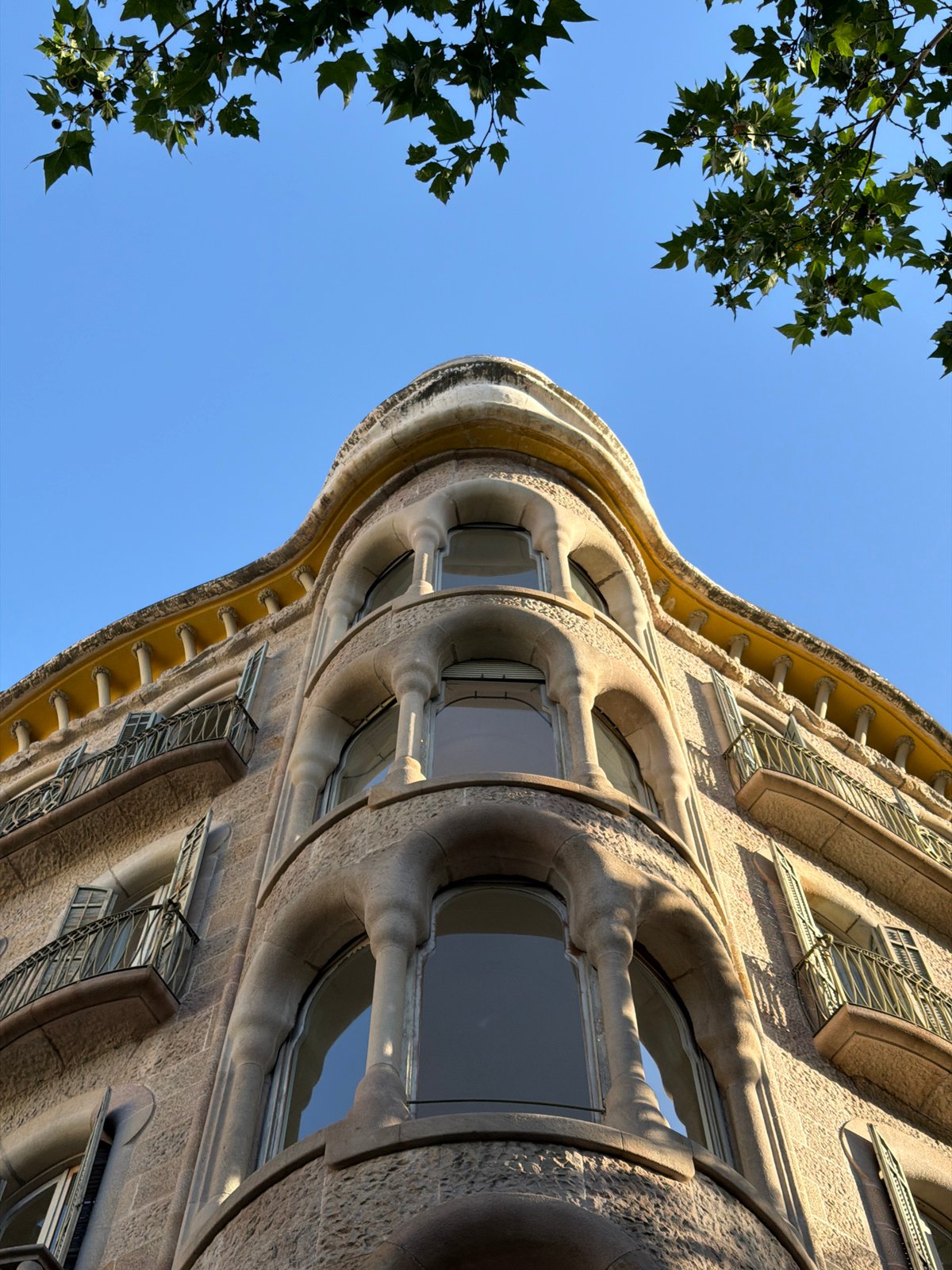 Tourist documents Gaudí architecture tour in Barcelona's Eixample district