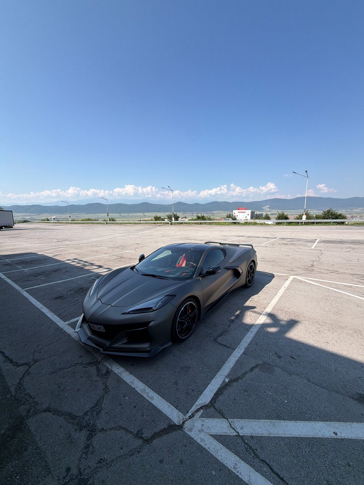 Corvette in a parking lot and framed photos on a wall in Ihtiman