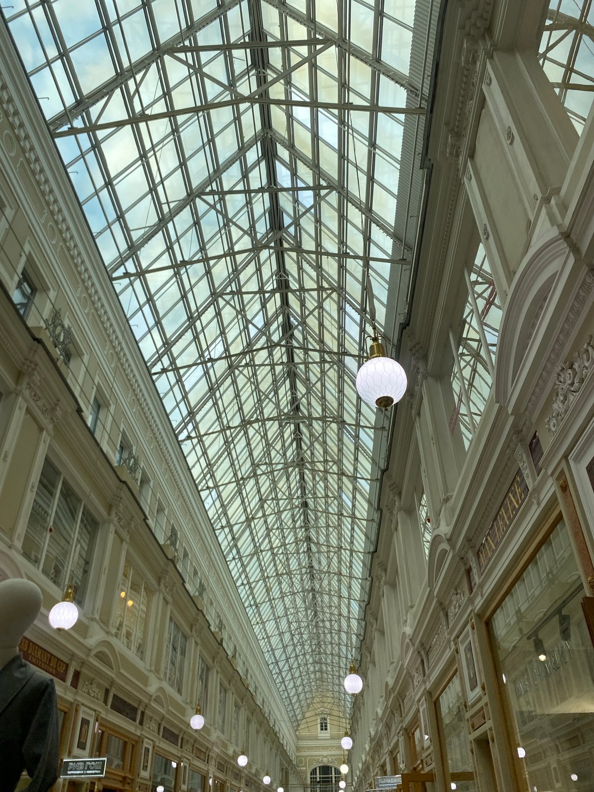 Tourists explore historic Passage shopping arcade in Saint Petersburg