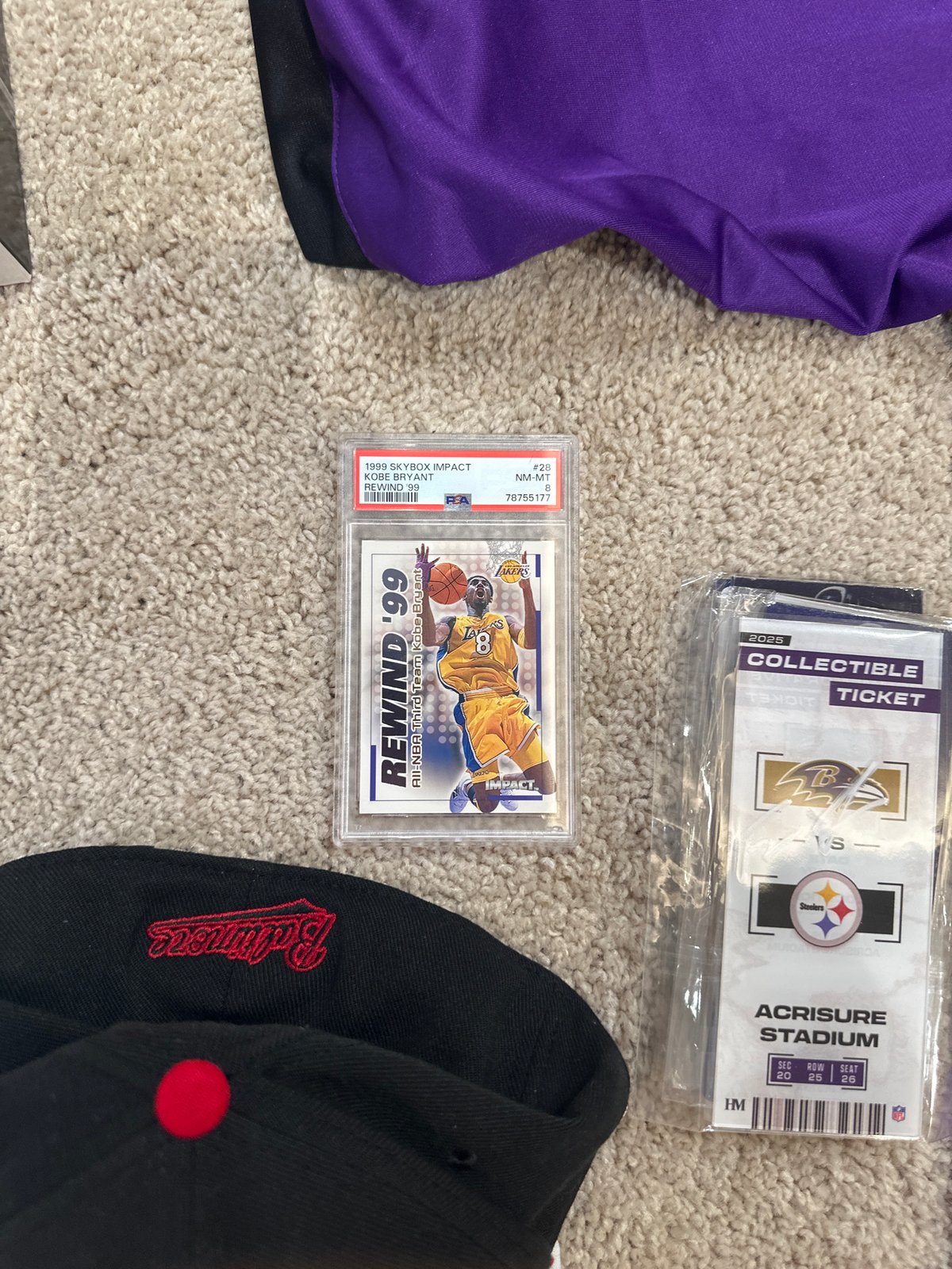 Sports memorabilia and personal items arranged on carpet in Aventura