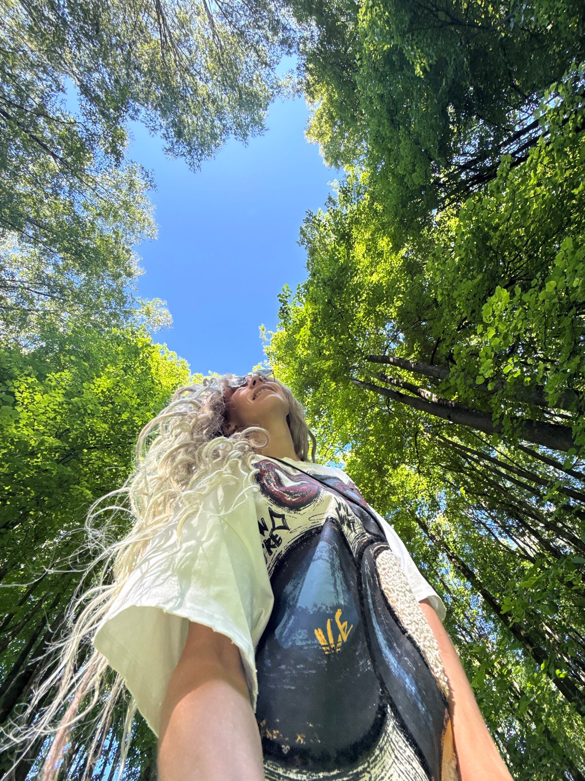 Woman photographed outdoors in sunny Rusanovo park setting