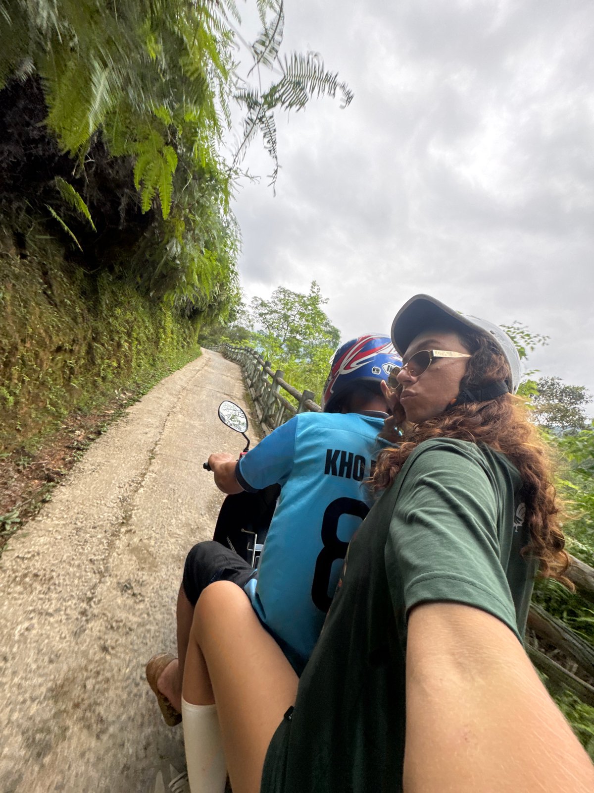Scooter riders travel scenic mountain paths in Vietnam commune