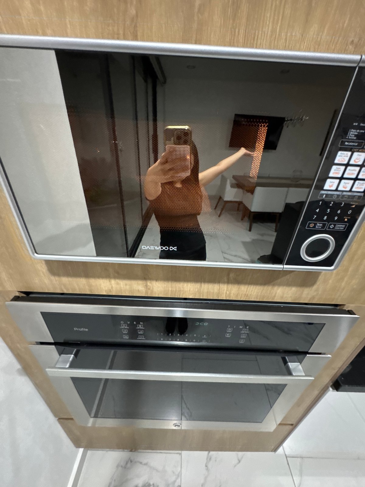 Person documents kitchen appliances in Puebla home