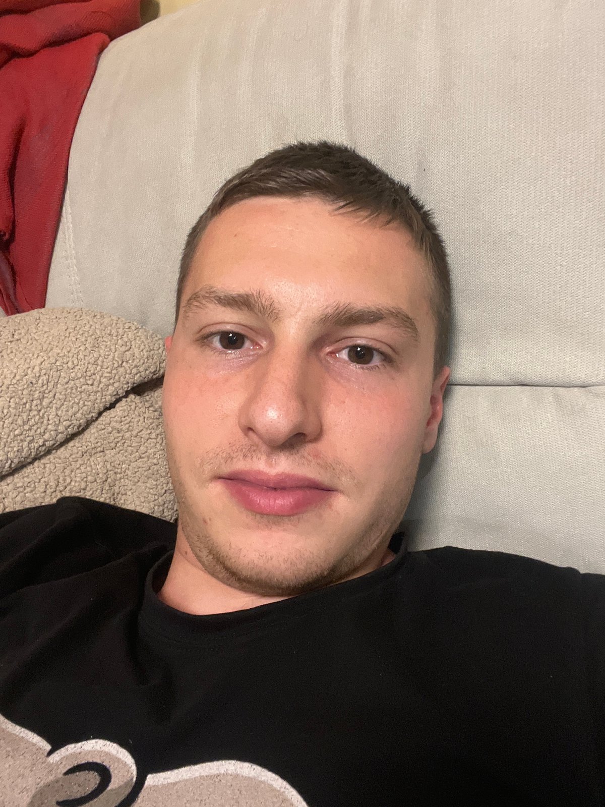 Man rests on sofa in Burgas apartment