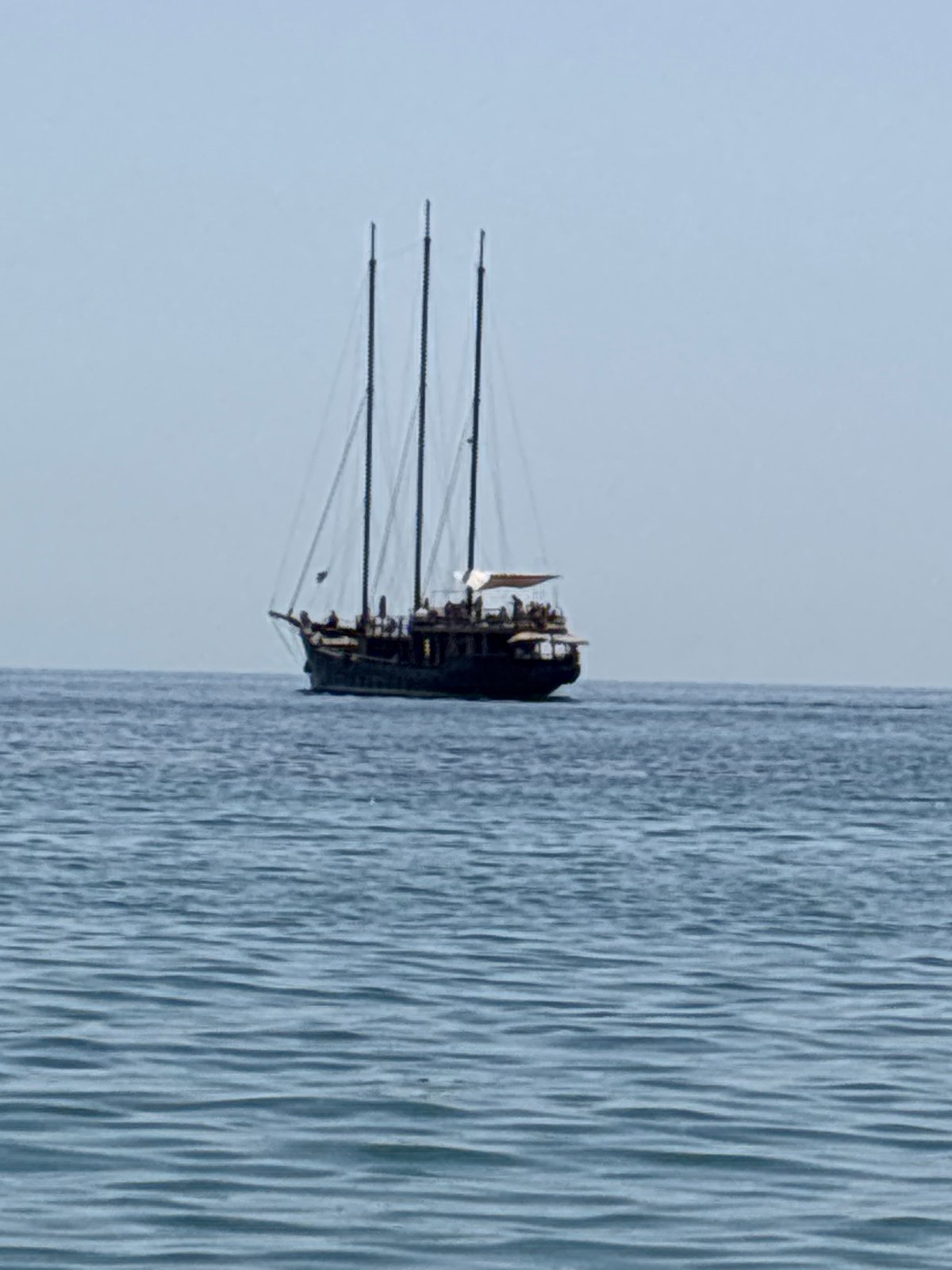 Three-masted tour sailboat cruising calm waters off southern Spain