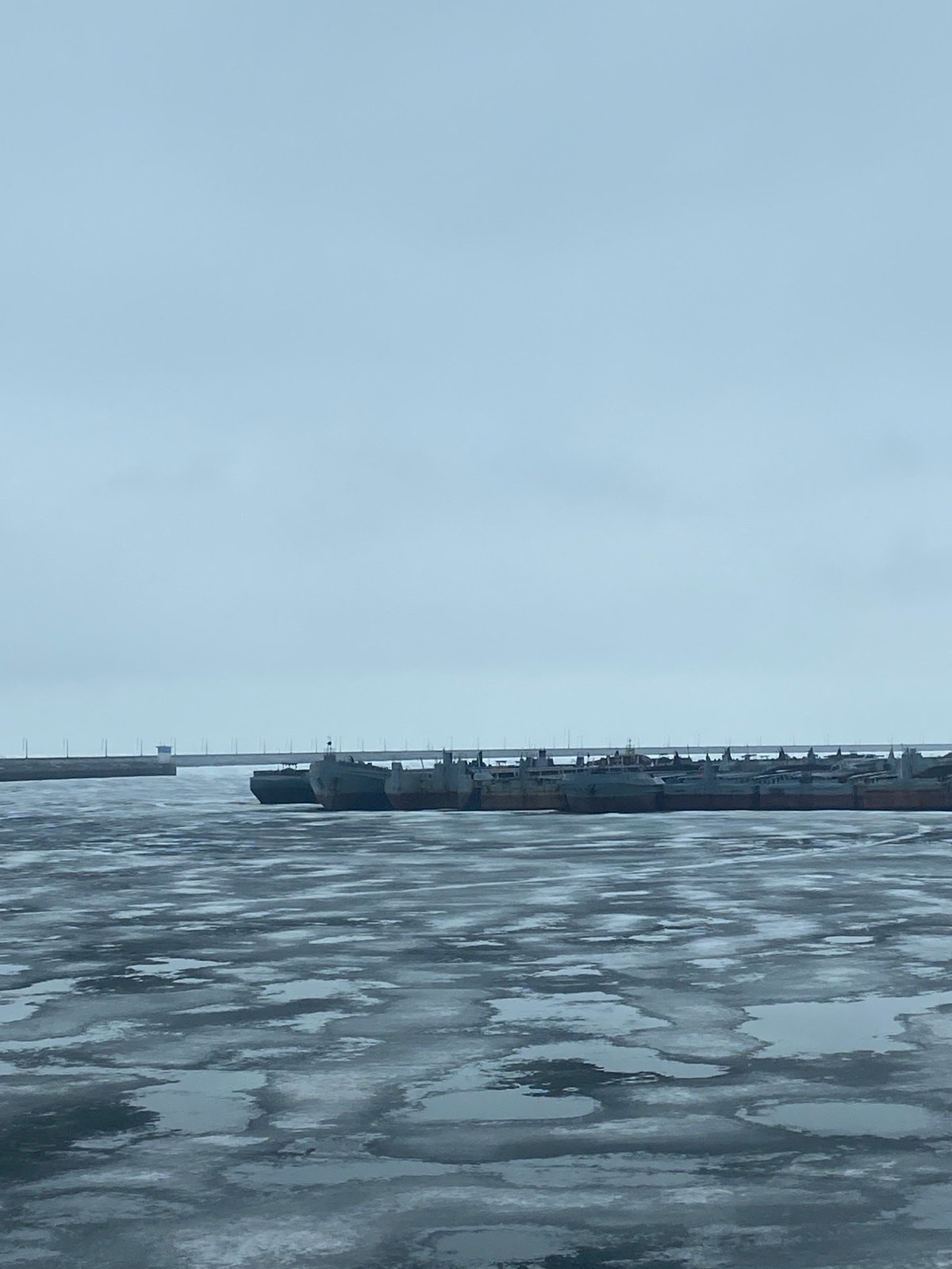 Ships docked at frozen pier in Chaikovsky, Russia