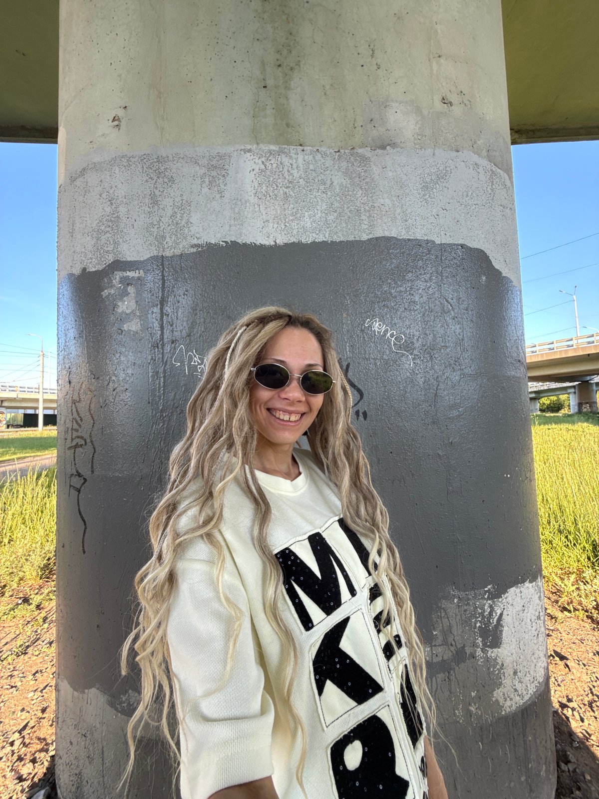 Woman with blonde dreadlocks photographed in Zavolzhye, Russia