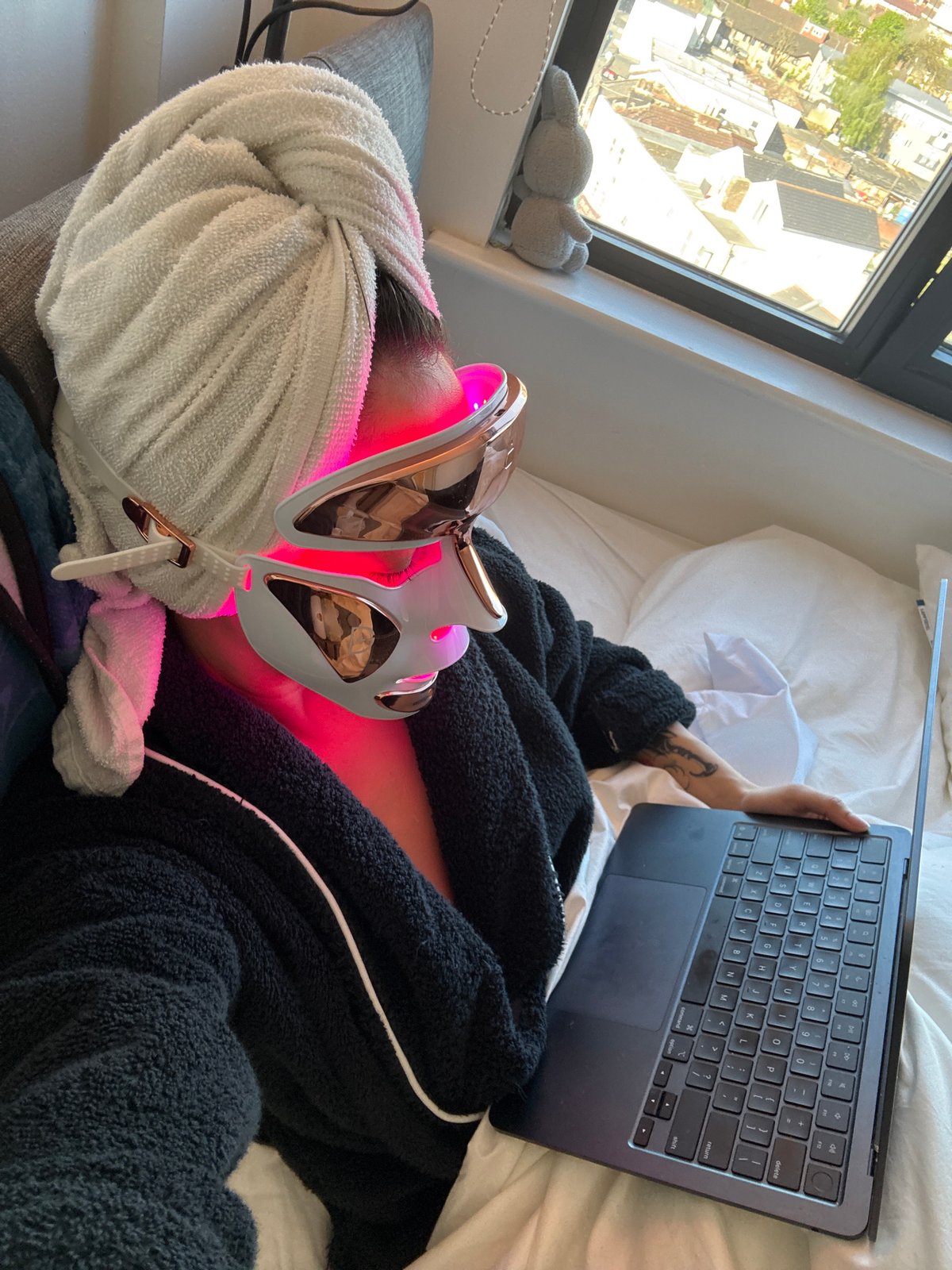 London resident uses LED face mask while relaxing indoors