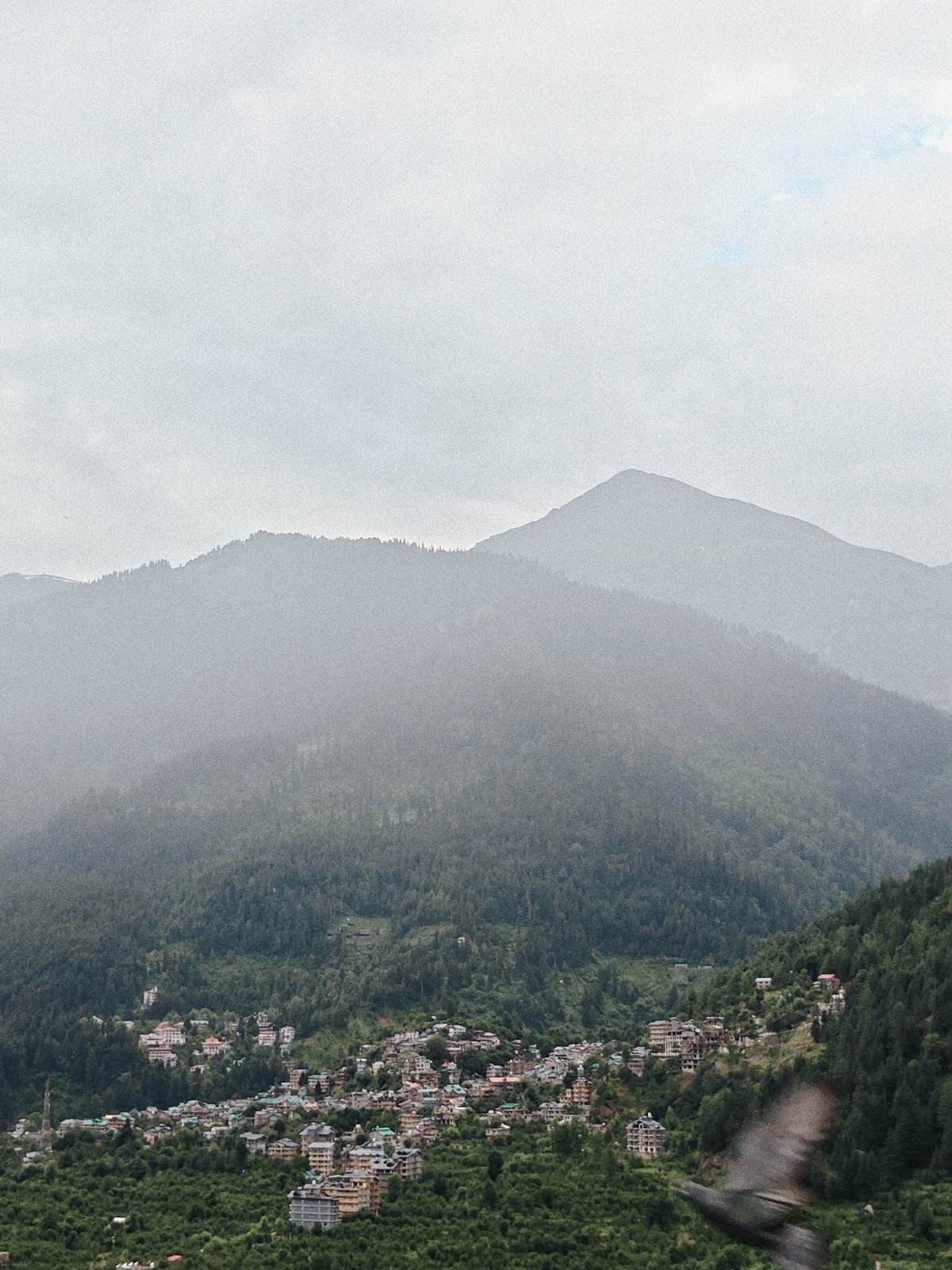 Misty morning in Vashisht: river, mountains, and town in focus