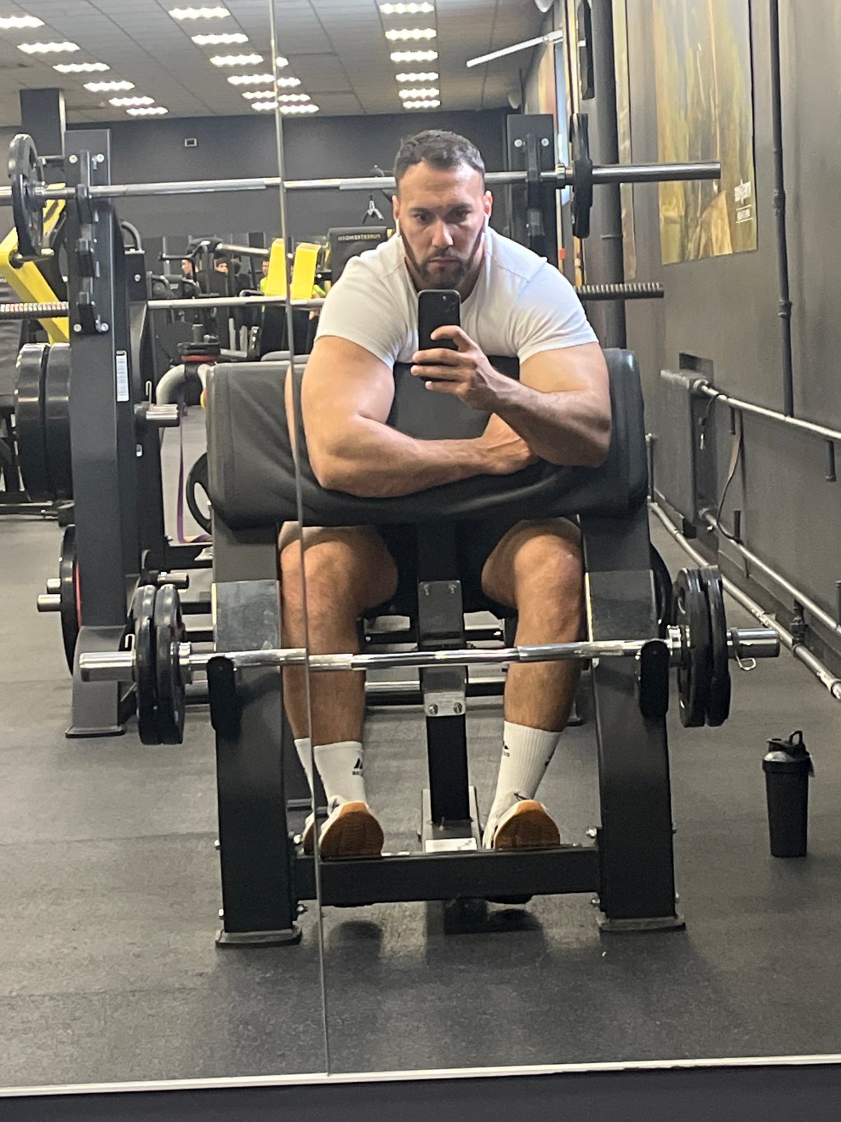 Man uses phone while exercising at Ulyanovsk gym