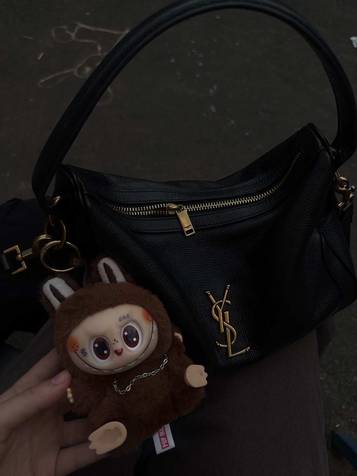 YSL handbag photographed on lap in Lyubertsy, Russia