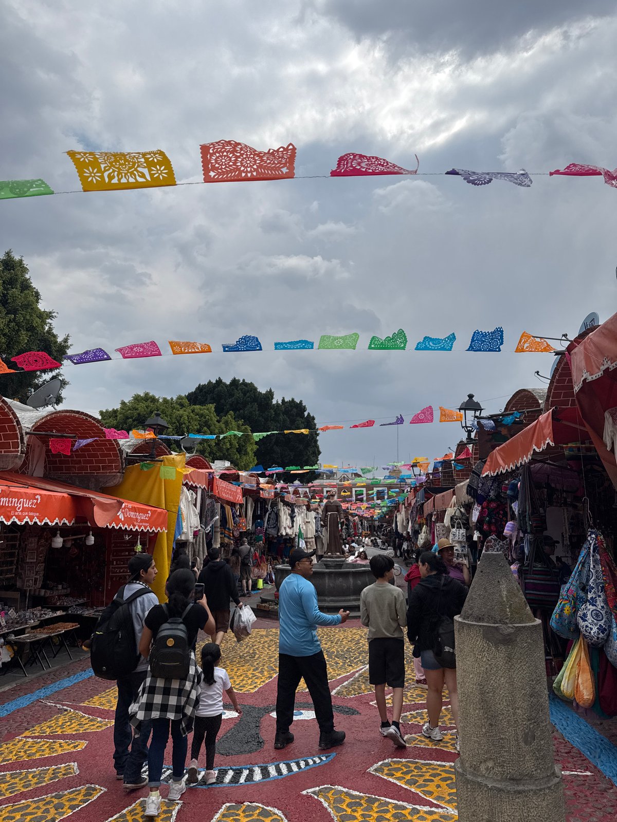 Evening street market bustling with shoppers in Puebla