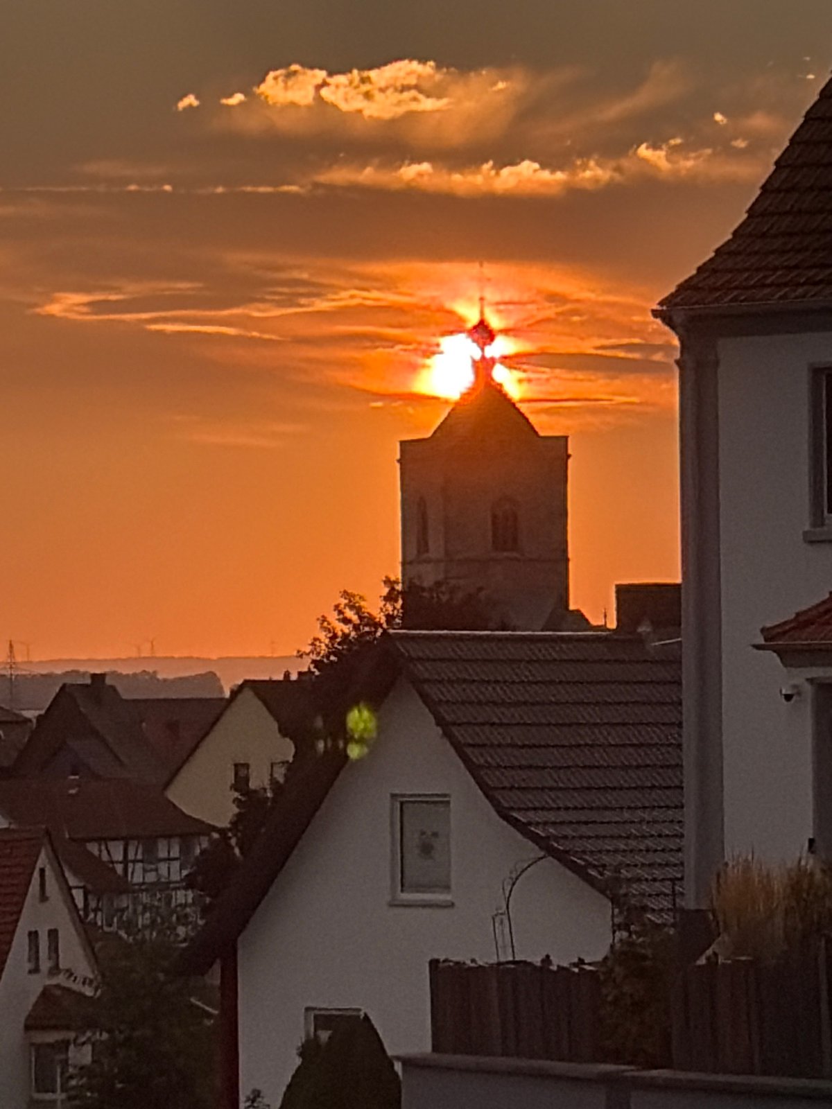 Urban sunset caught from two angles, warm sky over rooftops