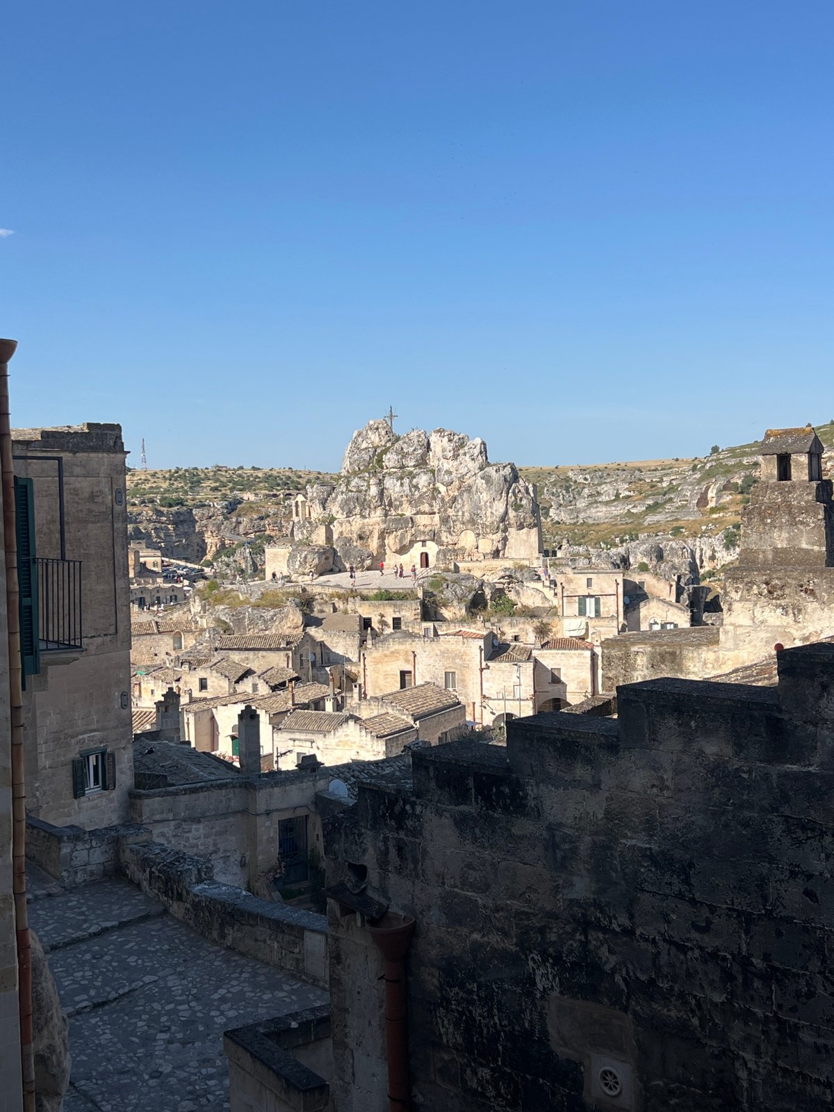 Tourist documents casual bread shopping, sightseeing in historic Matera district