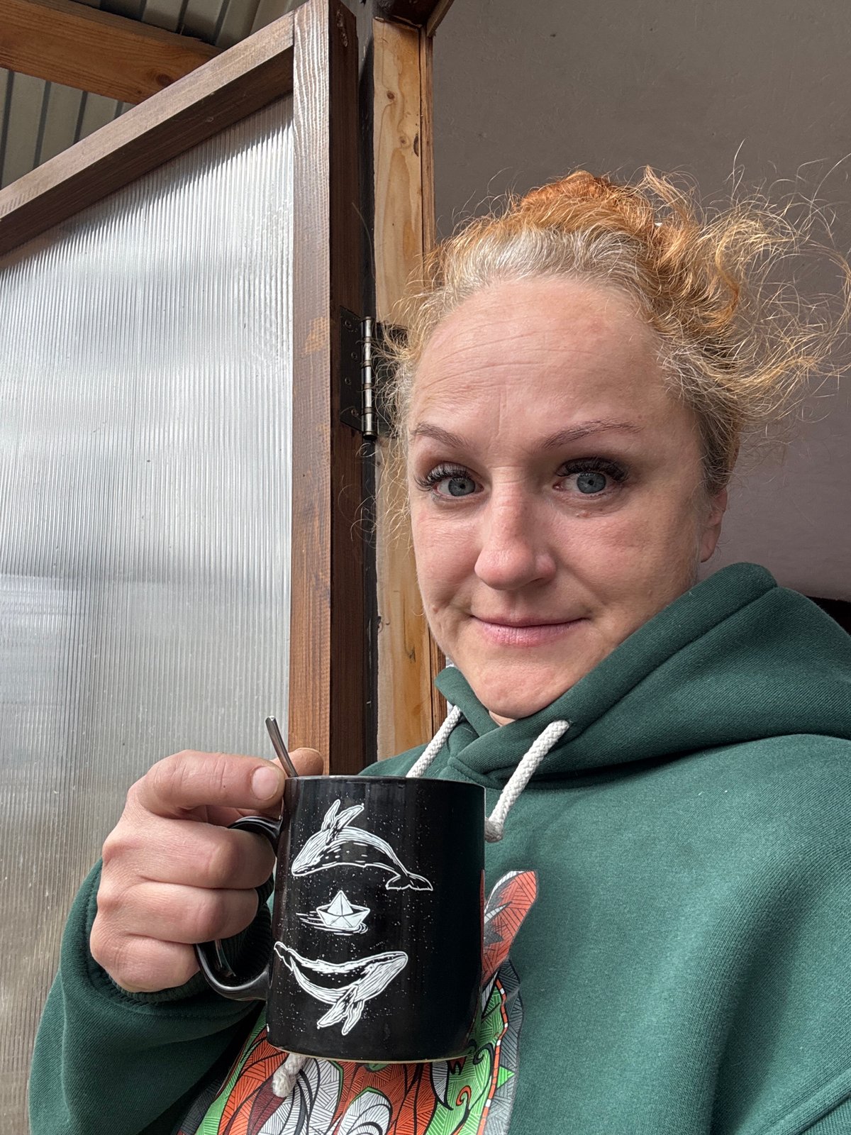 Woman enjoys morning breakfast with Boxer dog in Chaikovsky
