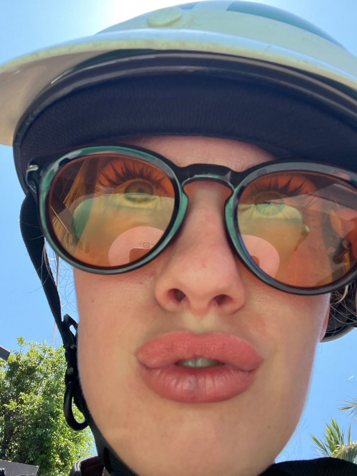 Helmet selfie, bathroom mirror, and a sunny riverfront view