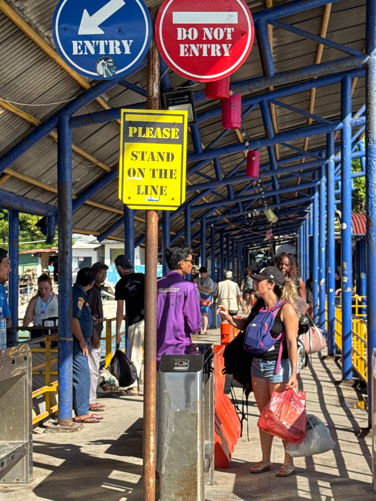 Busy Indonesian transportation hub and pier observed during morning hours