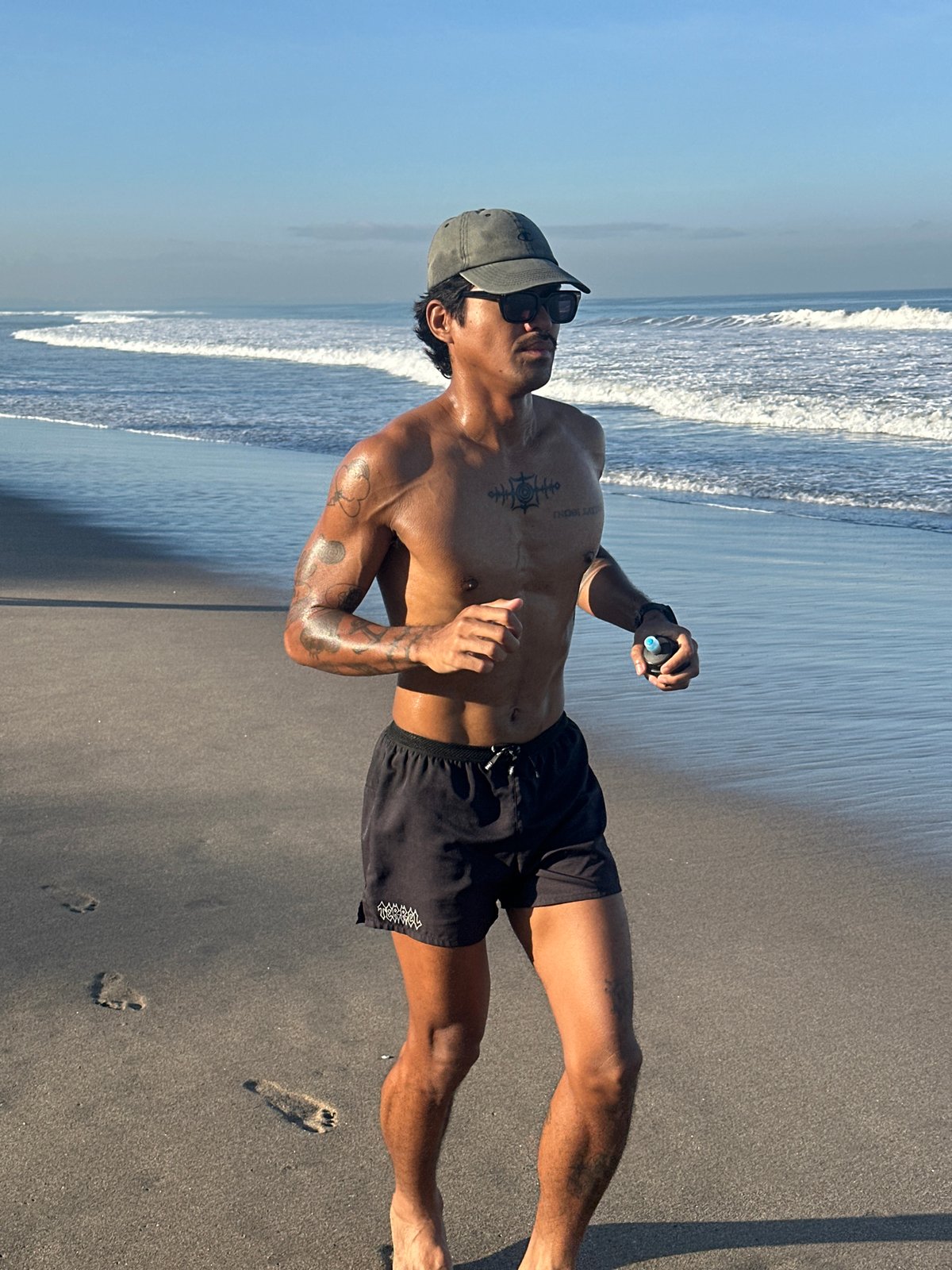 Morning beach life on Seminyak's shore, dogs and all