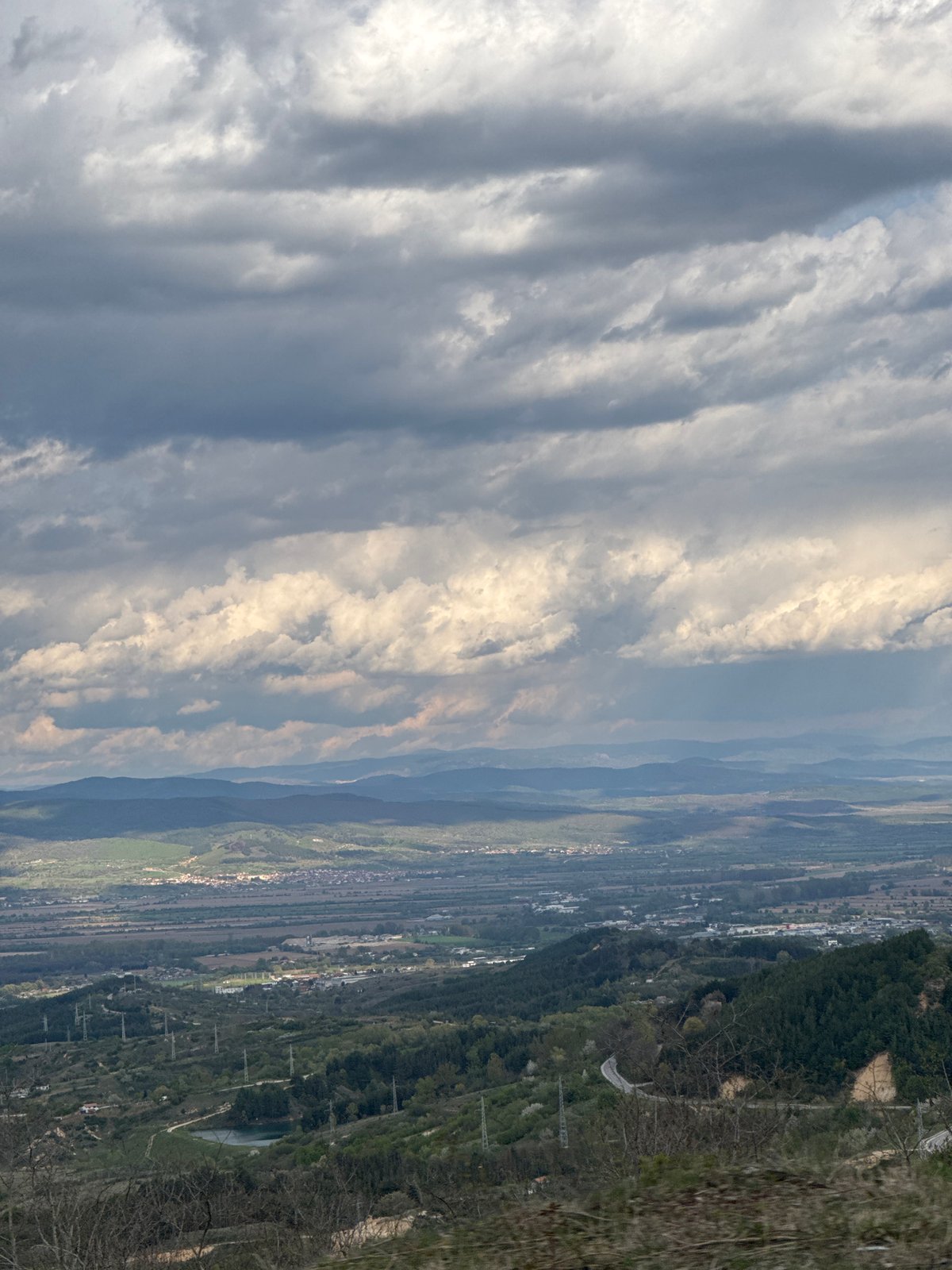 Valley landscape with buildings documented under cloudy skies