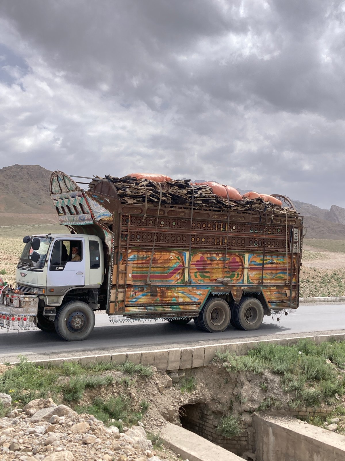 Decorated truck spotted carrying cargo on Pakistan mountain road