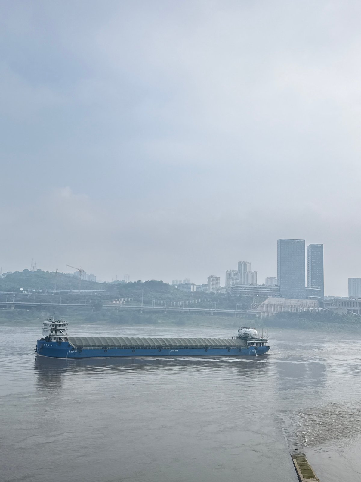 Quiet morning activity along Jiangjin's riverside promenade