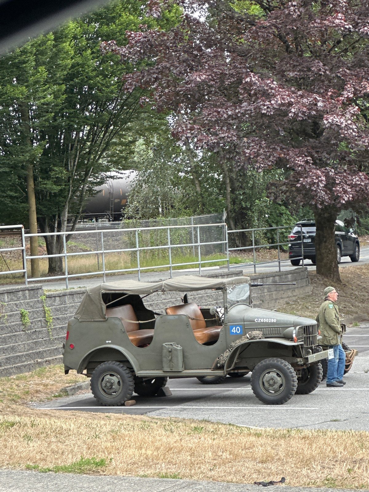 Vintage military jeep parked beside a concrete retaining wall